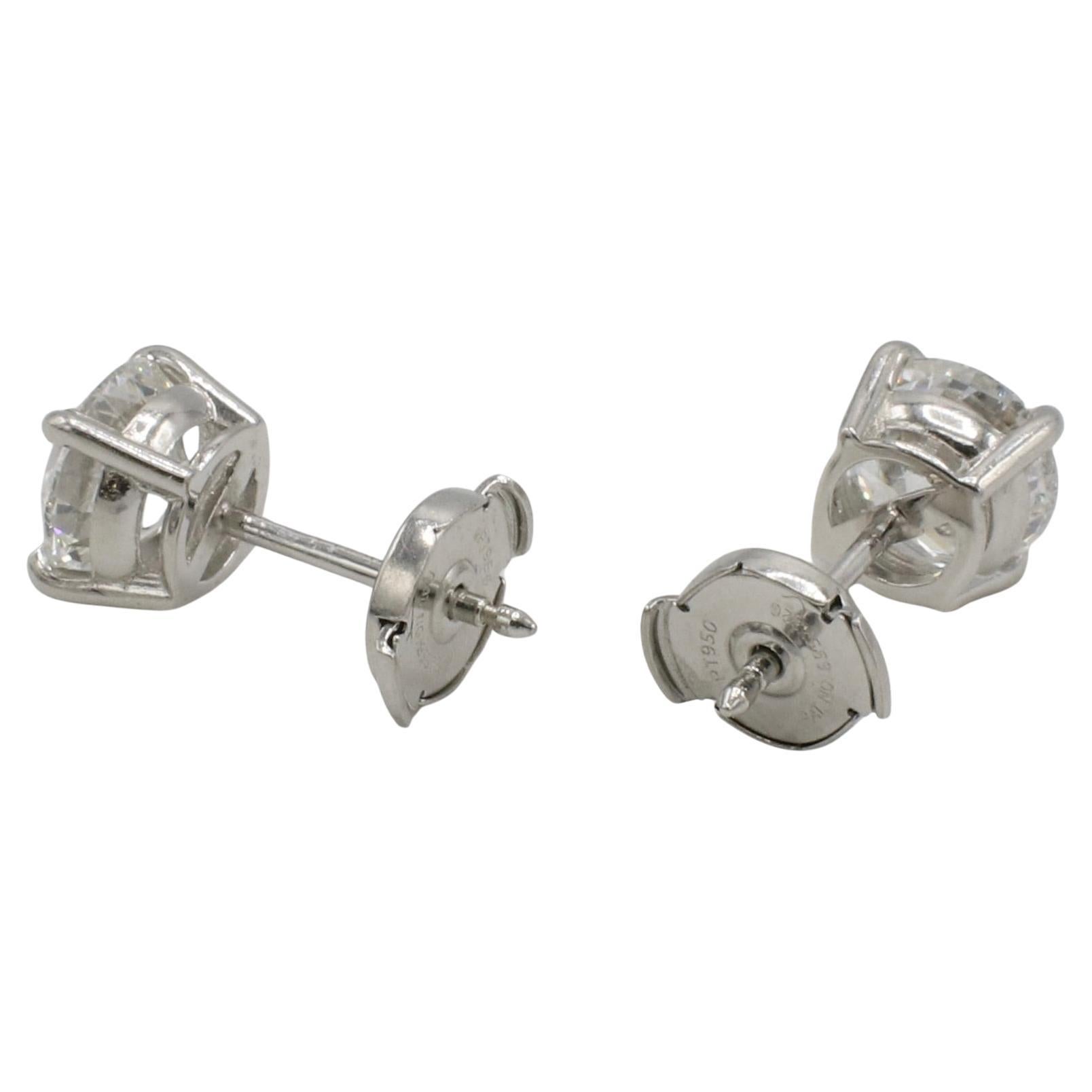 GIA Certified 2.12 Carat F SI2 Round Natural Diamond Four Prong Stud Earrings 
GIA report numbers: 6302000055, 6292669603 
Diamonds: 1.06 F SI2 & 1.06 F SI2 round natural diamonds
Metal: Platinum
Weight: 2.79 grams
Backs: Locking backs (post)
