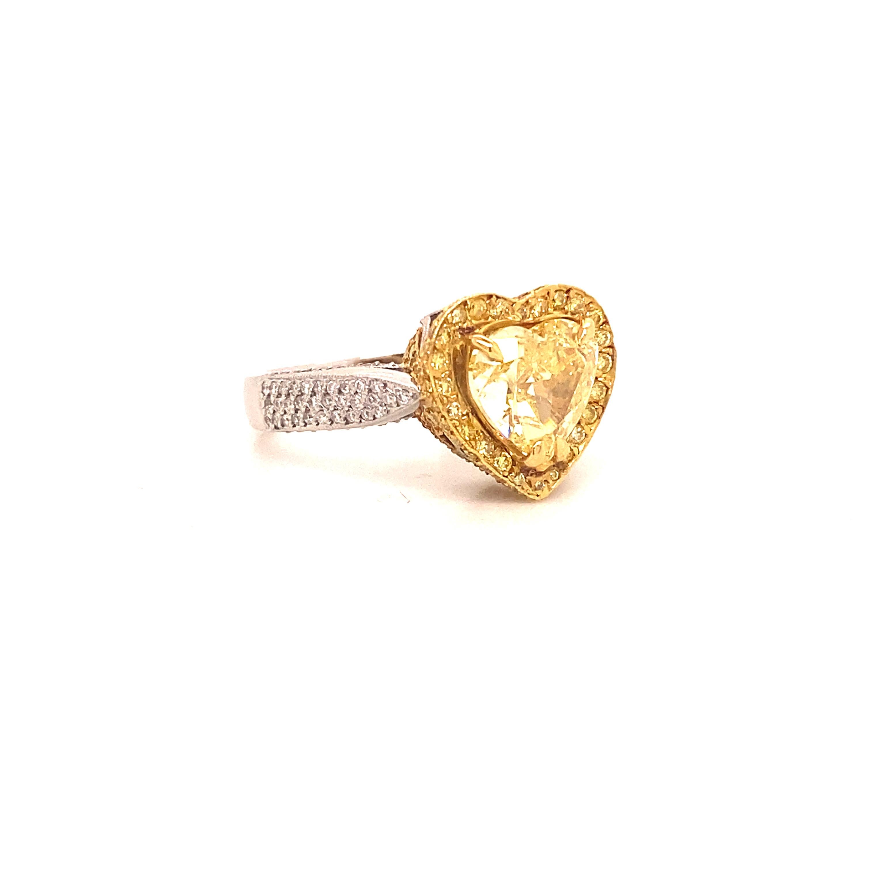 Fancy Intense Yellow Diamond Heart Shape Ring

This ring features a unique natural fancy intense yellow diamond in its center. It is GIA certified as a fancy intense yellow diamond weighing 2.16 carats. It is surrounded by the seamless color of