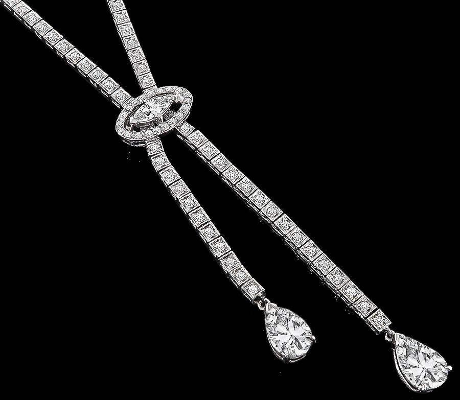 Made of 14k white gold, this necklace features 2 sparkling GIA certified pear shape diamonds that weigh 1.04ct and 1.12ct. graded D/VS1 and D/SI2.
The pear shape diamonds are accentuated by dazzling marquise and round cut diamonds that weigh