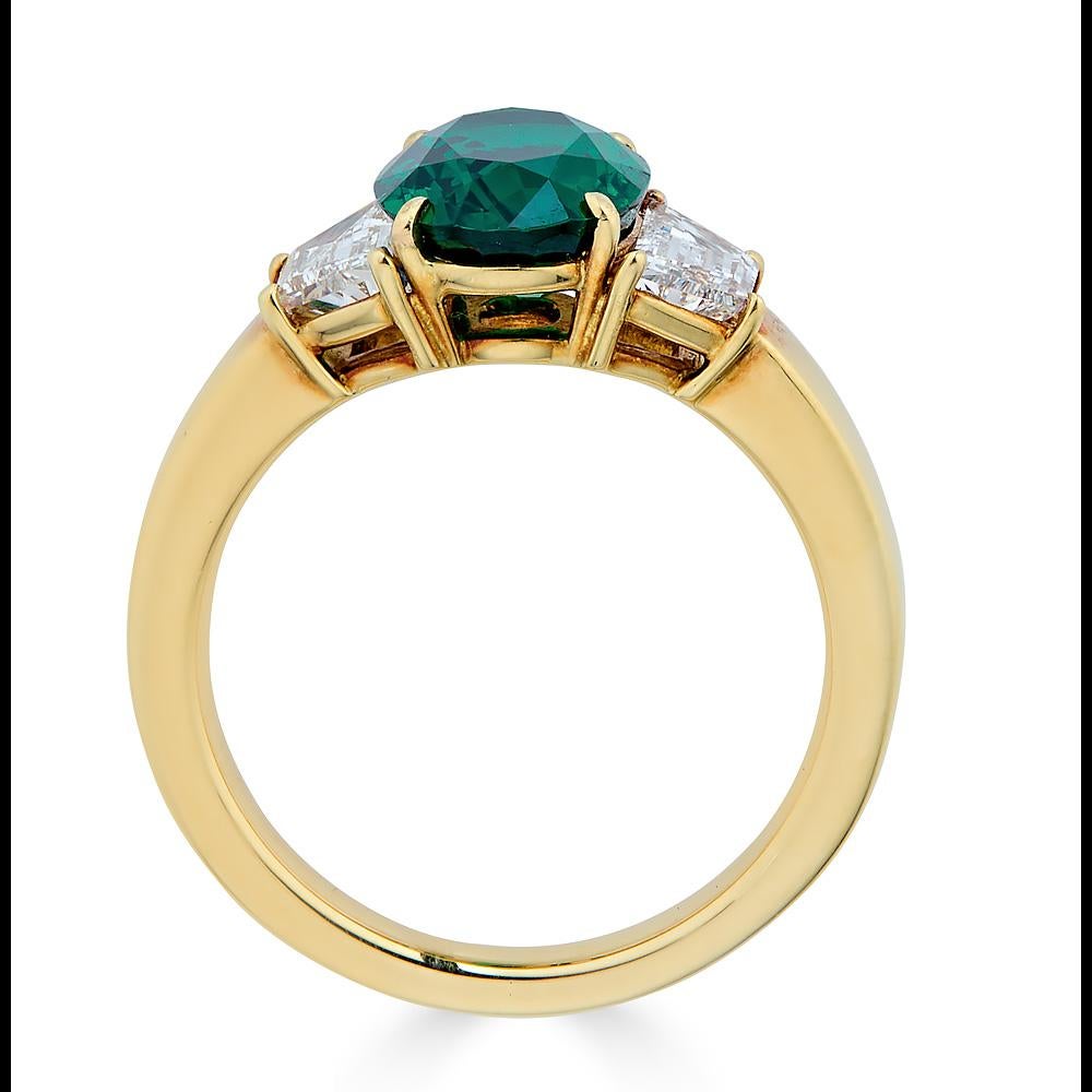 Crafted in 18K Yellow Gold, the center is adorned by a GIA Certified vivid green emerald with Eye Clean Clarity .

A rarity of nature, weighing 2.17 carats.

Size: Emerald: 2.17 ct./Diamond: 0.881 ct
Color: Vivid Green 
Treatment: Non Oil
Made in