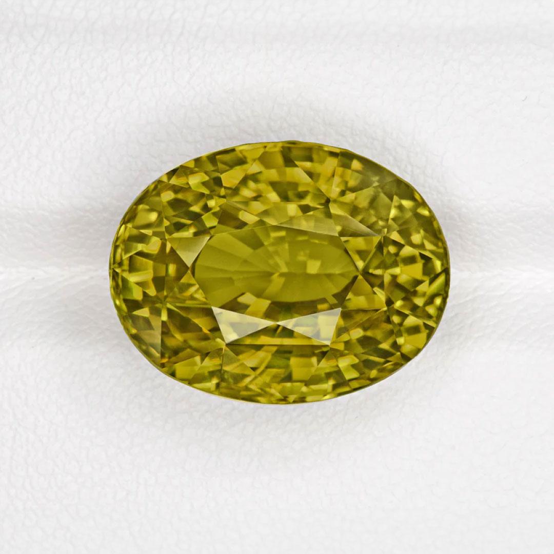 This stunning oval over 21 carat genuine alexandrite – a rare color-change variety of chrysoberyl – is a vibrant yellow-green in natural lighting and shifts in a very strong color change effect to a brownish yellow. Mined in Madagascar and cut