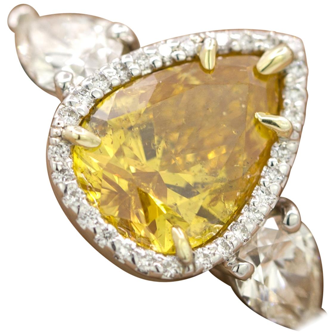 GIA Certified 2.20 Carat Pear Brilliant Vivid Yellow-Orange Diamond 3-Stone Ring
