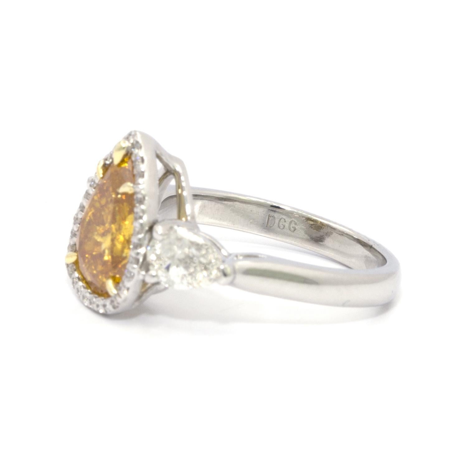Contemporary GIA Certified 2.20 Carat Pear Brilliant Vivid Yellow-Orange Diamond 3-Stone Ring For Sale