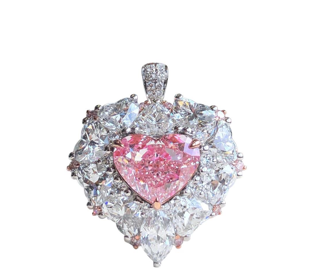 We invite you to discover this majestic ring set with a 2.21 carats GIA certified heart cut Faint Pink diamond accented with colorless pear shape diamonds of 3,305 carats in total all GIA certified. Versatile, you can also wear it as a magnificent