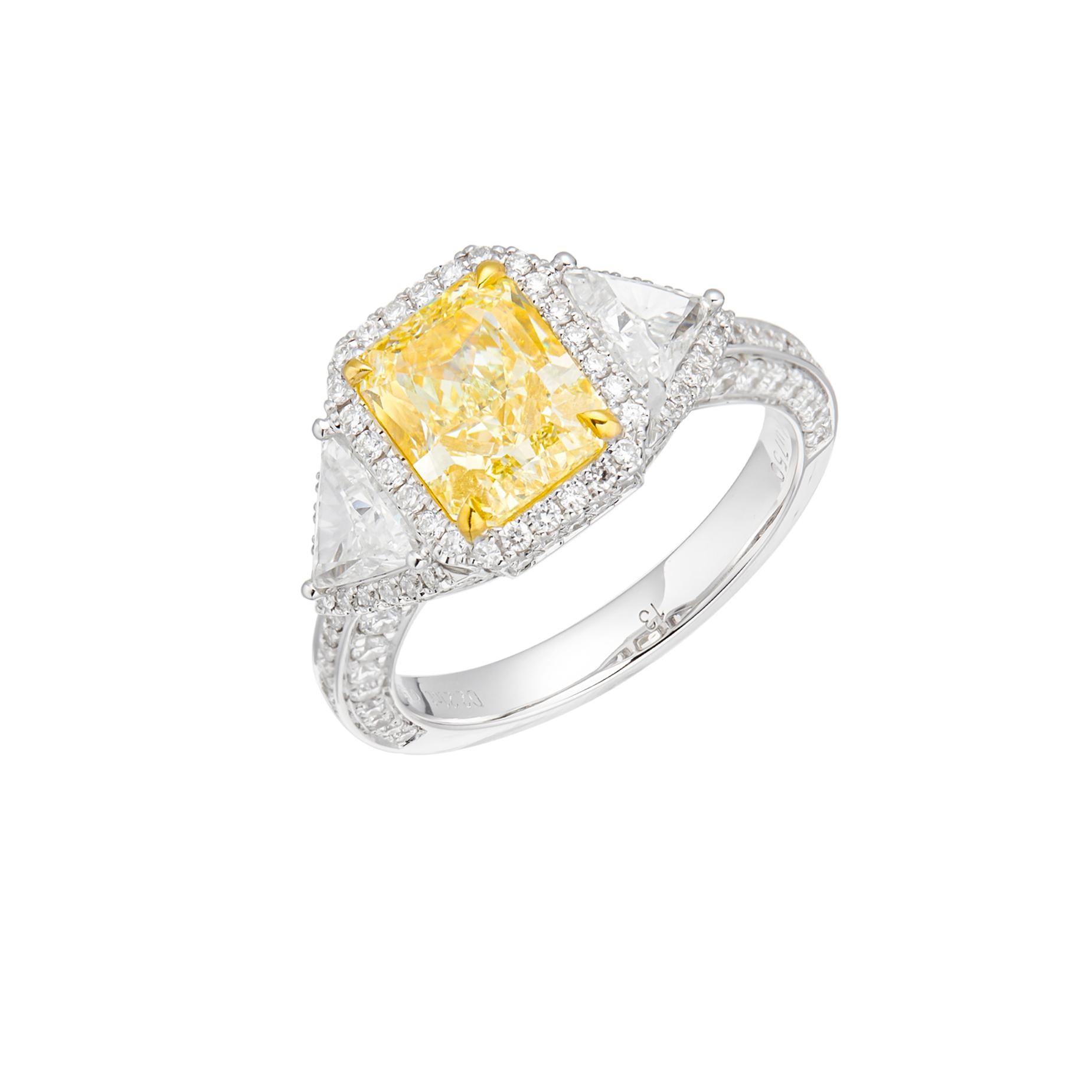 Behold a masterpiece of brilliance and radiance – a GIA Certified 2.21 carat Natural Radiant Cut Fancy Light Yellow Diamond Solitaire Ring, elegantly set on a bed of 18kt gold. This extraordinary piece captures the essence of sophistication and