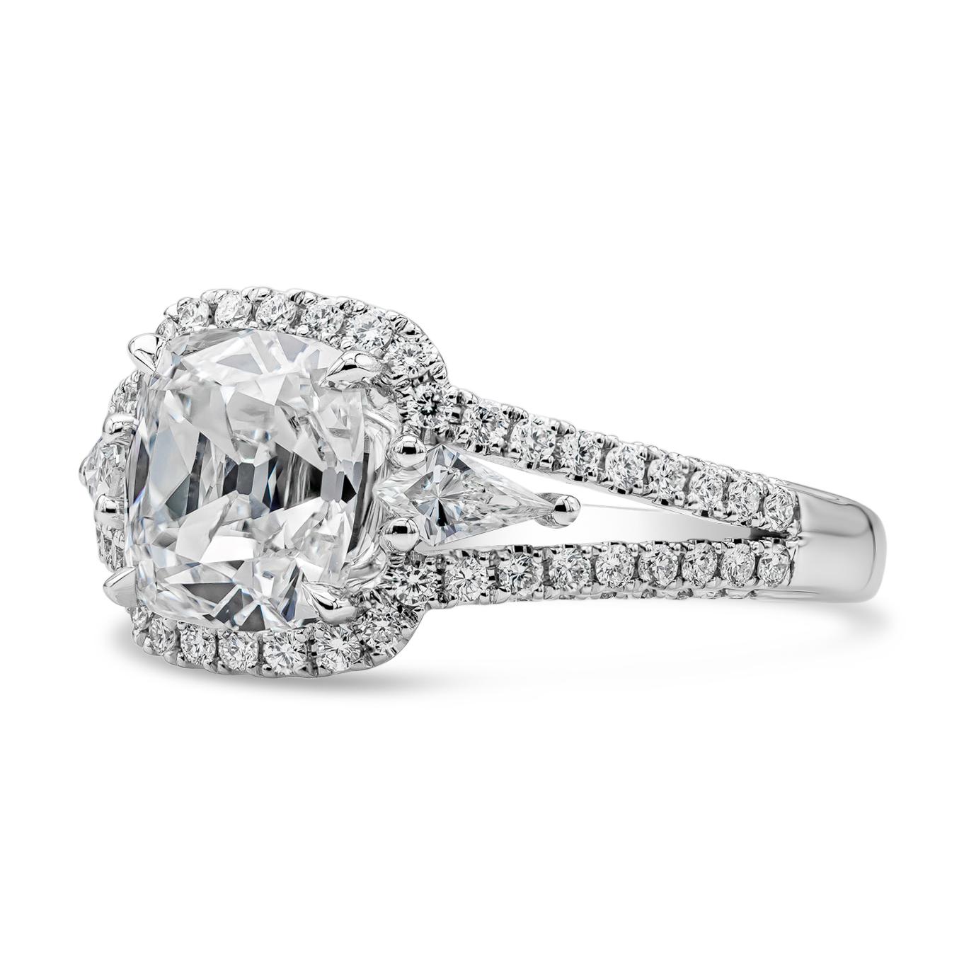 This elegant three stone halo engagement ring style showcasing a GIA certified 2.22 carats cushion cut diamond, G color and VS1 in clarity.  Flanked by brilliant kite cut diamonds on each side, set in a diamond encrusted split-shank setting made in