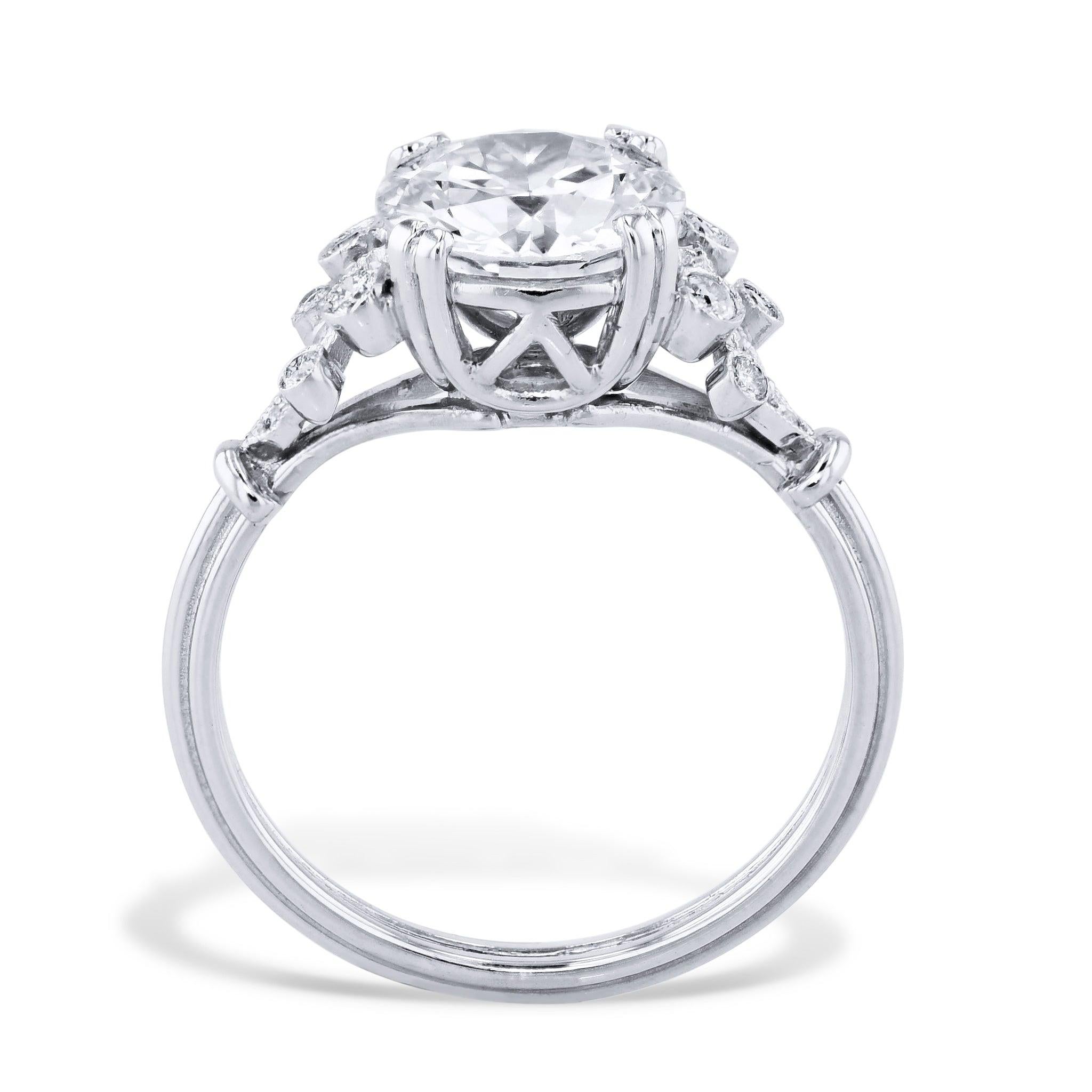 This exquisite Transitional Cut Diamond Platinum Engagement Ring includes a refined center diamond with a captivating VG/G finish - authenticated by G.I.A. certificate # 5221284821. 
16 glittering diamonds decorate the handcrafted H&H Collection