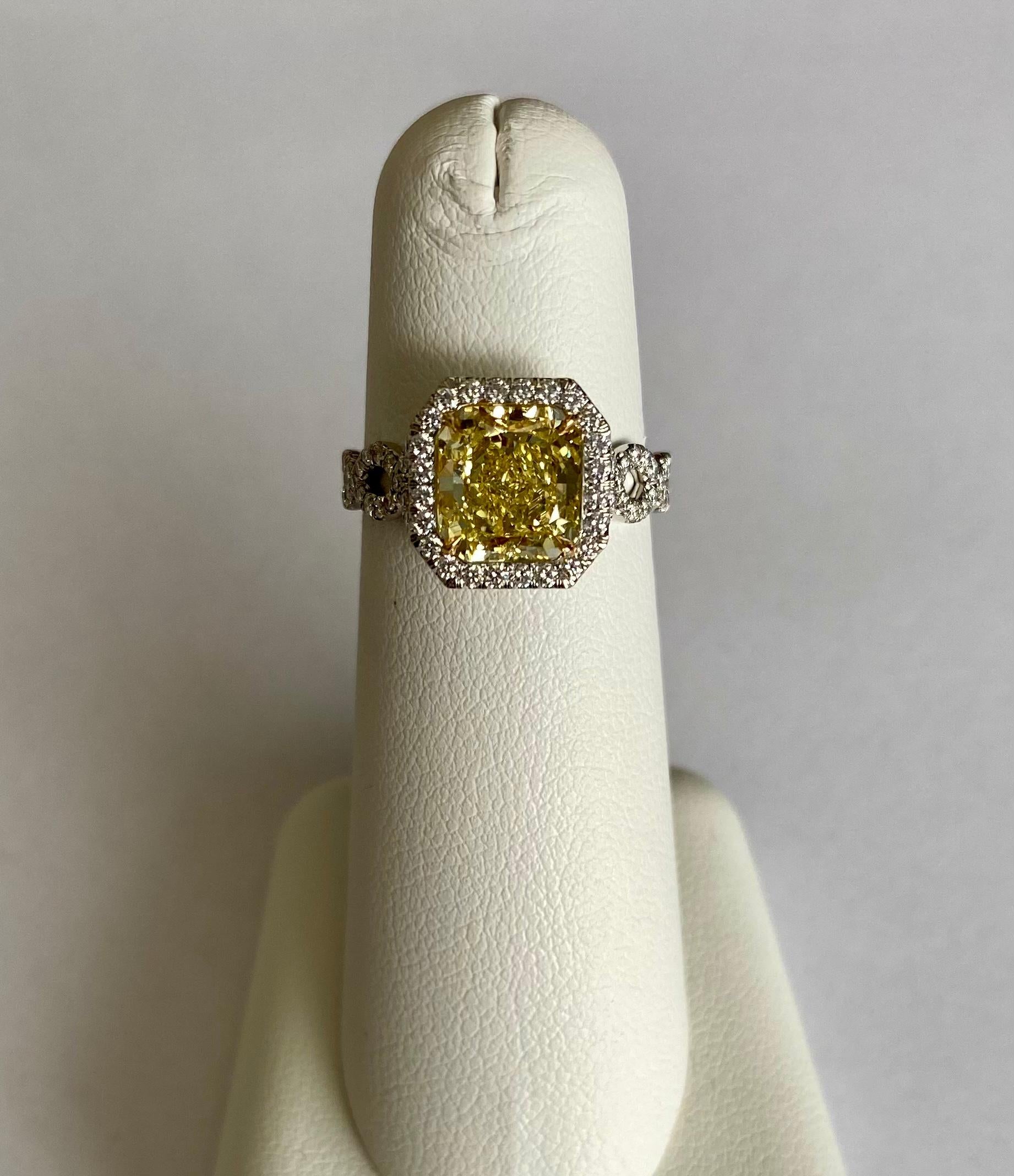 Stunning radiant cut Fancy Intense Yellow VS2 weighting 2.23 carats (GIA 2185057032) set in handmade platinum ring with 89  round brilliant cut diamonds D-E-F color VS clarity, DTW. 0.48ct, finger size 6.

Viewings available in our NYC wholesale