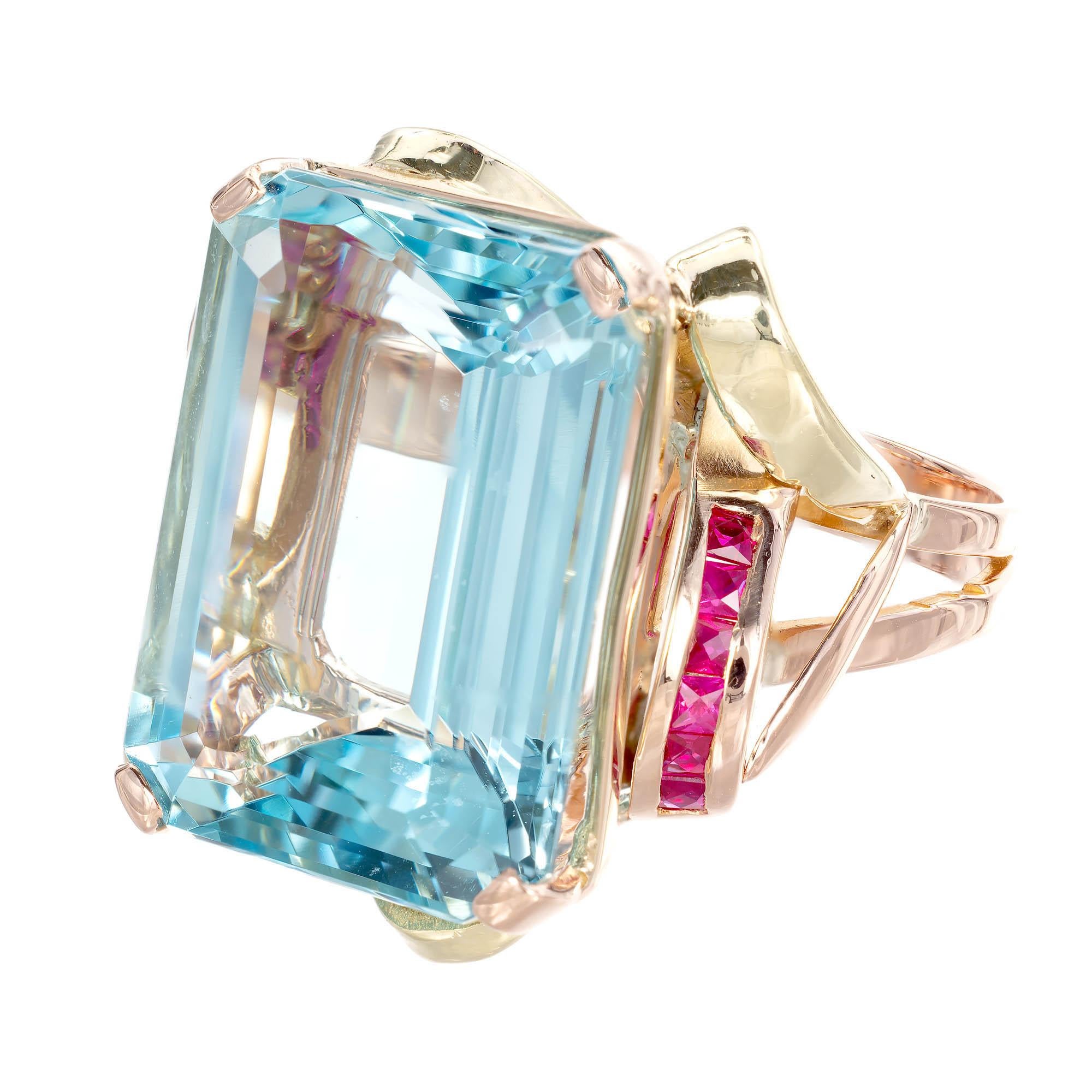 Vintage Aquamarine & Ruby ring. Octagonal deep blue Aquamarine set in a primarily rose color 14k gold ring with French cut Rubies channel set at opposite corners with yellow gold music note shapes opposite corners & front and back of ring.

1
