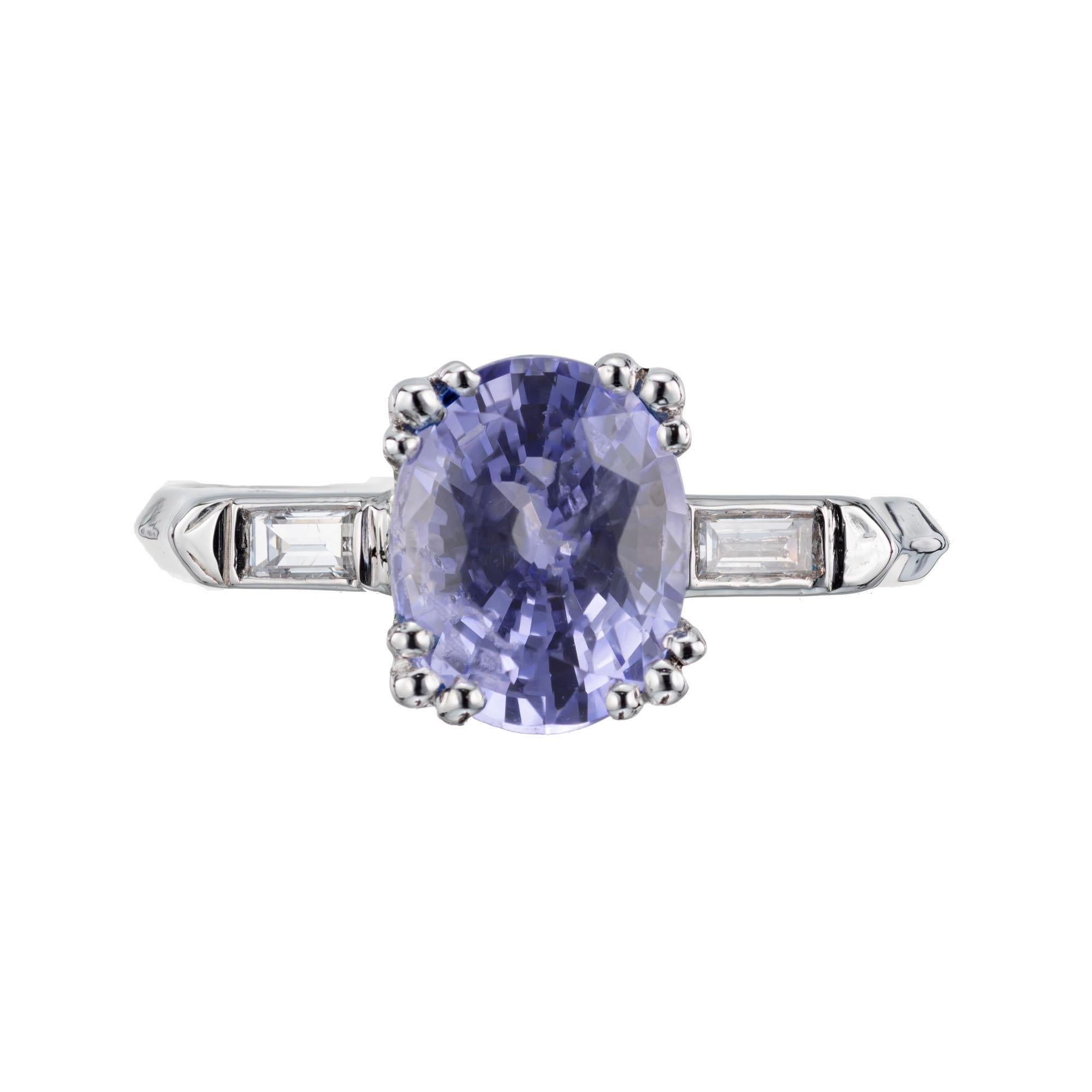 Vintage 1940's sapphire and diamond engagement ring. GIA certified periwinkle oval center sapphire with two baguette side diamonds set in a platinum three-stone setting. 

1 oval violet periwinkle blue sapphire H SI, approx. 2.24cts GIA Certificate