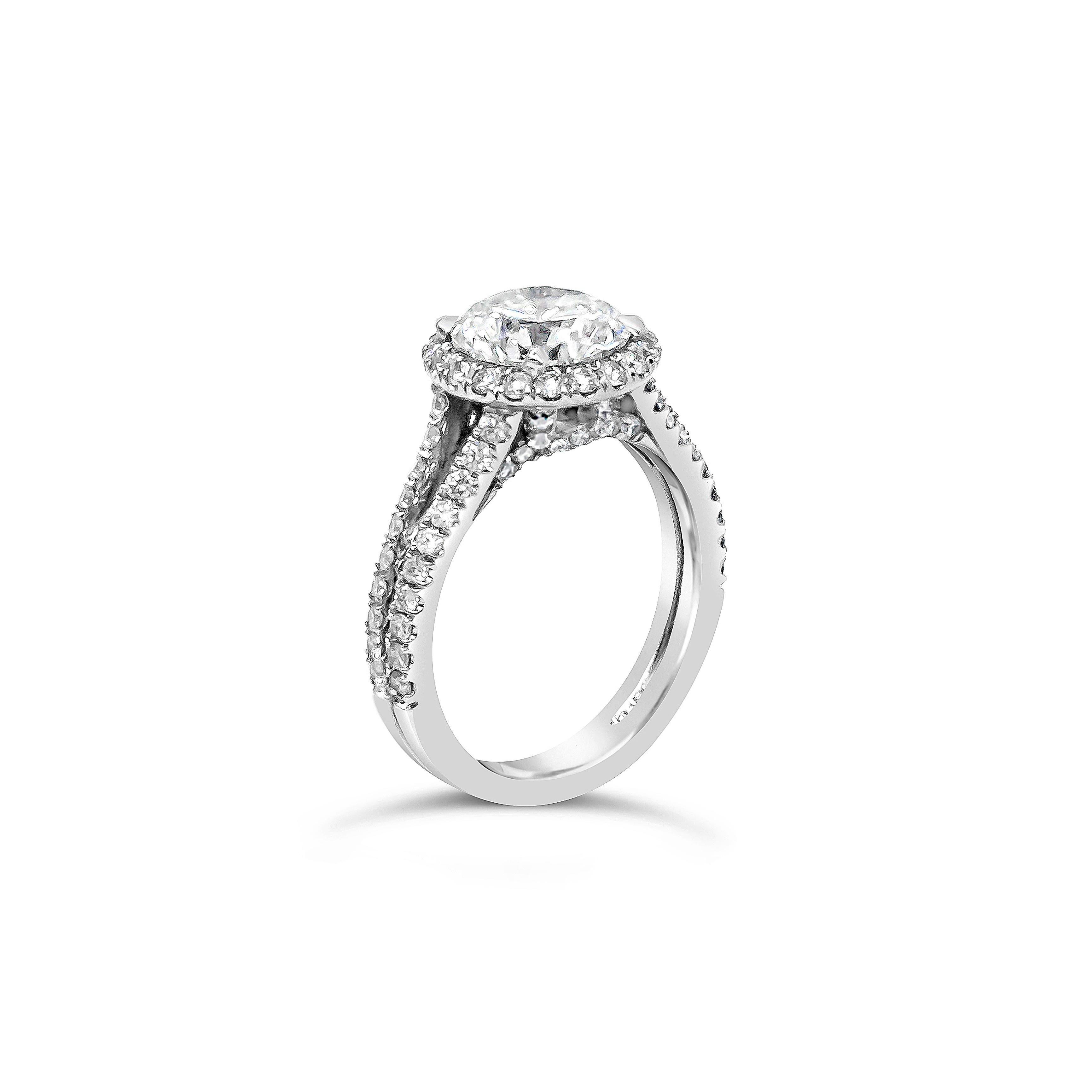 Features a center stone of 2.24 carats round brilliant diamond, GIA certified as F color and I1 in clarity. Set in a halo of diamonds and a split shank half eternity setting thats is accented with diamonds. Accent diamonds weigh 0.85 carats total.
