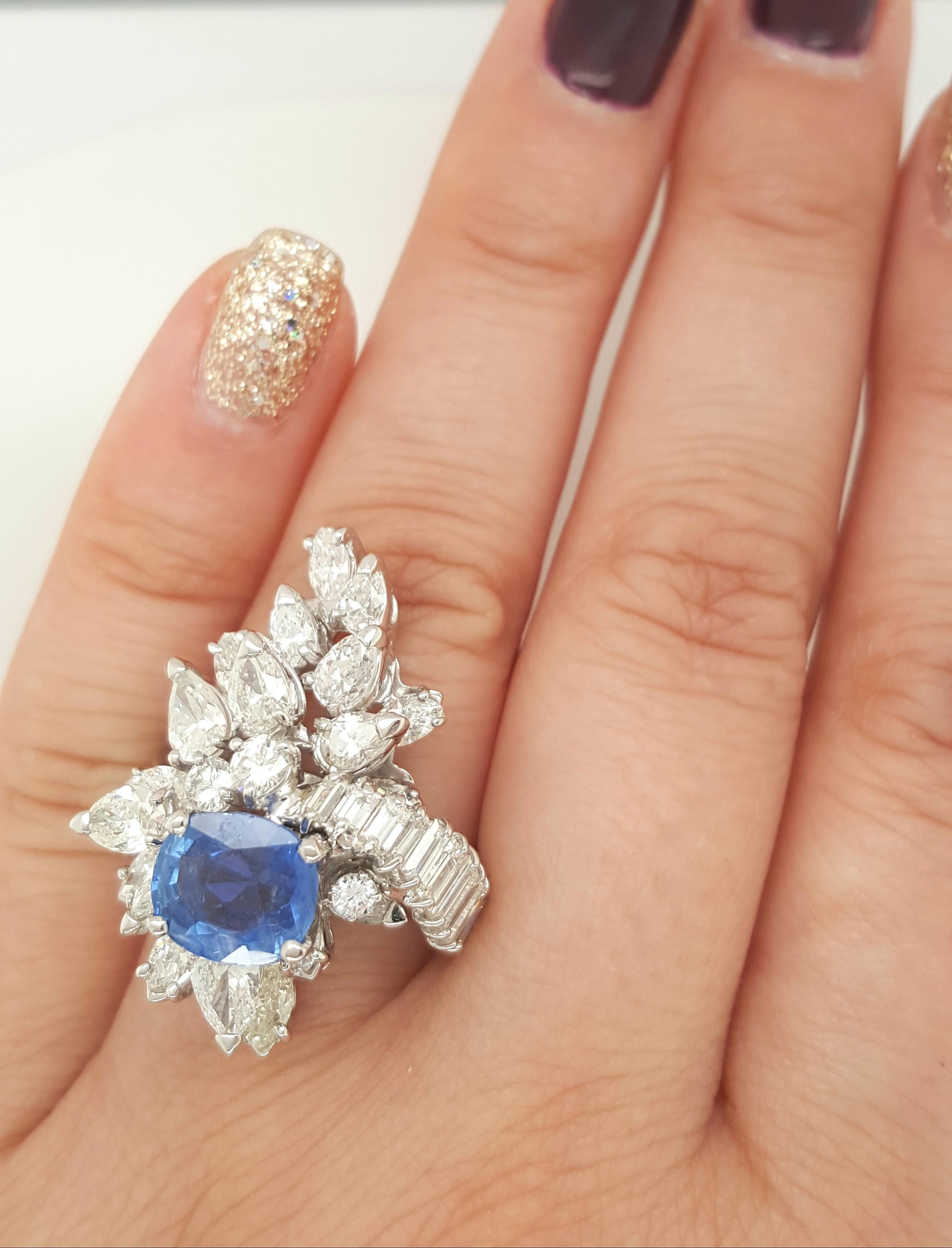 An original true vintage sapphire and diamond cocktail ring! The center is a natural GIA Certified 2.26 carat Burma NO heat oval blue sapphire. It is accented 12 Baguette, 4 Round, 11 Pear and 9 Marquise cut diamonds weighing 5.07 carats total. This