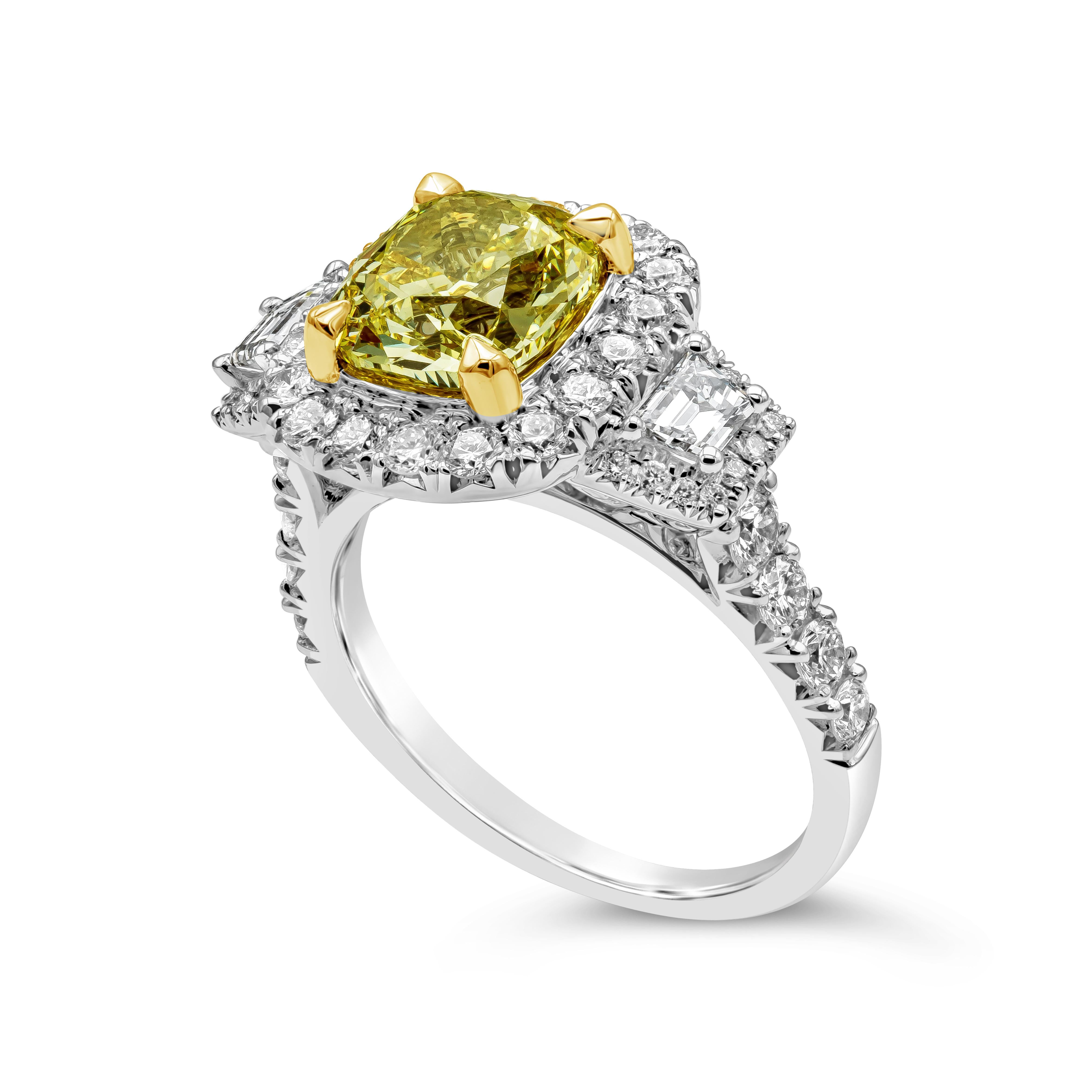 A beautiful engagement ring, showcasing a color-rich 2.26 carats cushion cut diamond certified by GIA as Fancy Yellow color and SI2 clarity, set on a classic four claw prong basket made of 18K yellow gold. Accented by a halo of round brilliant cut