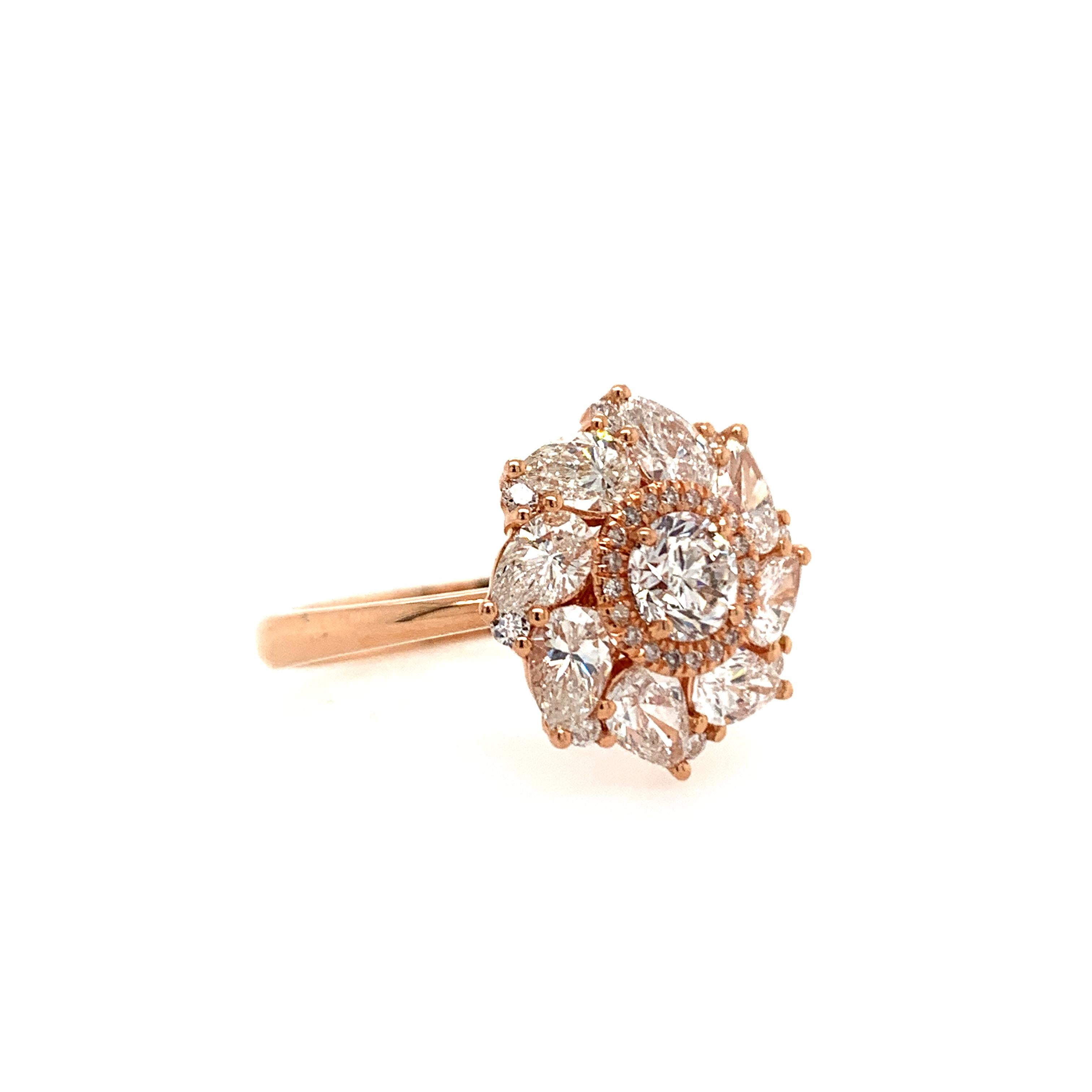 This beautiful ring flaunts a 0.70 carat round natural white diamond surrounded by a diamond halo and set atop a bed of round and pear-shaped diamonds.

Set in 14K rose gold.

Center stone: Natural white diamond - 0.70 carat, color G, clarity SI1