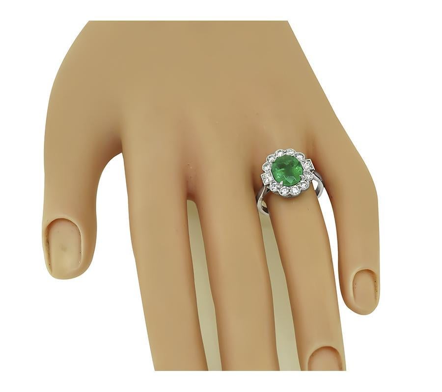 This is a charming platinum engagement ring. The ring is centered with a lovely GIA certified oval cut emerald that weighs 2.26ct. The emerald is accentuated by sparkling round and princess cut diamonds that weigh approximately 0.82ct. The color of
