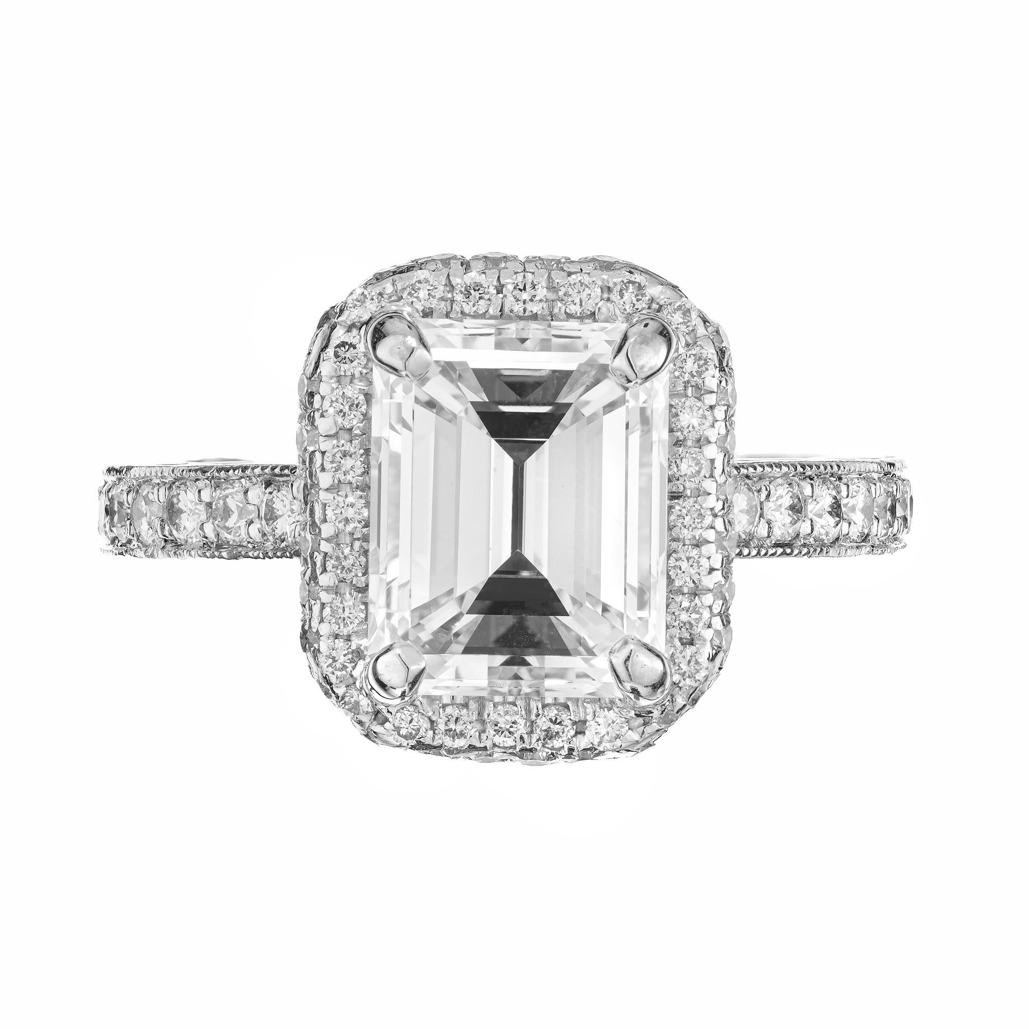 Stunning diamond halo engagement ring. Sparkly GIA Certified 2.27 Carat emerald cut diamond in a wonderful engagement ring with a micro pave halo. The center piece of this ring is a 2.27 emerald cut diamond which is graded by the GIA as near