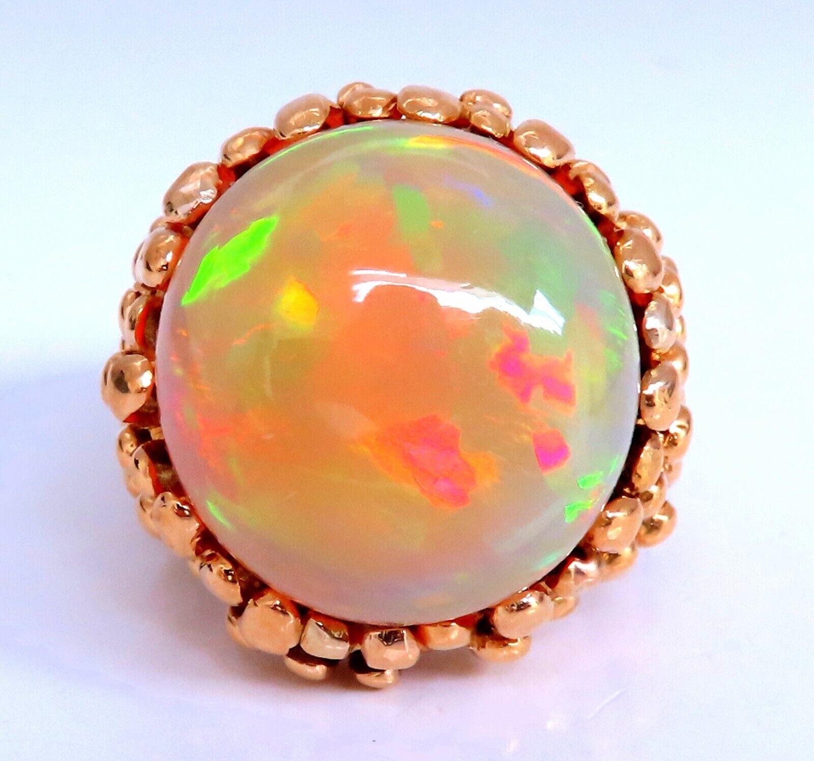Play of color.

GIA Certified 

22.85ct. Natural Non treated Opal ring.

Report: 6224937405

Round cut: 19.79 X 18.90  X 12.12mm

threads of greens, orange and some yellows.

Phenomenon: 