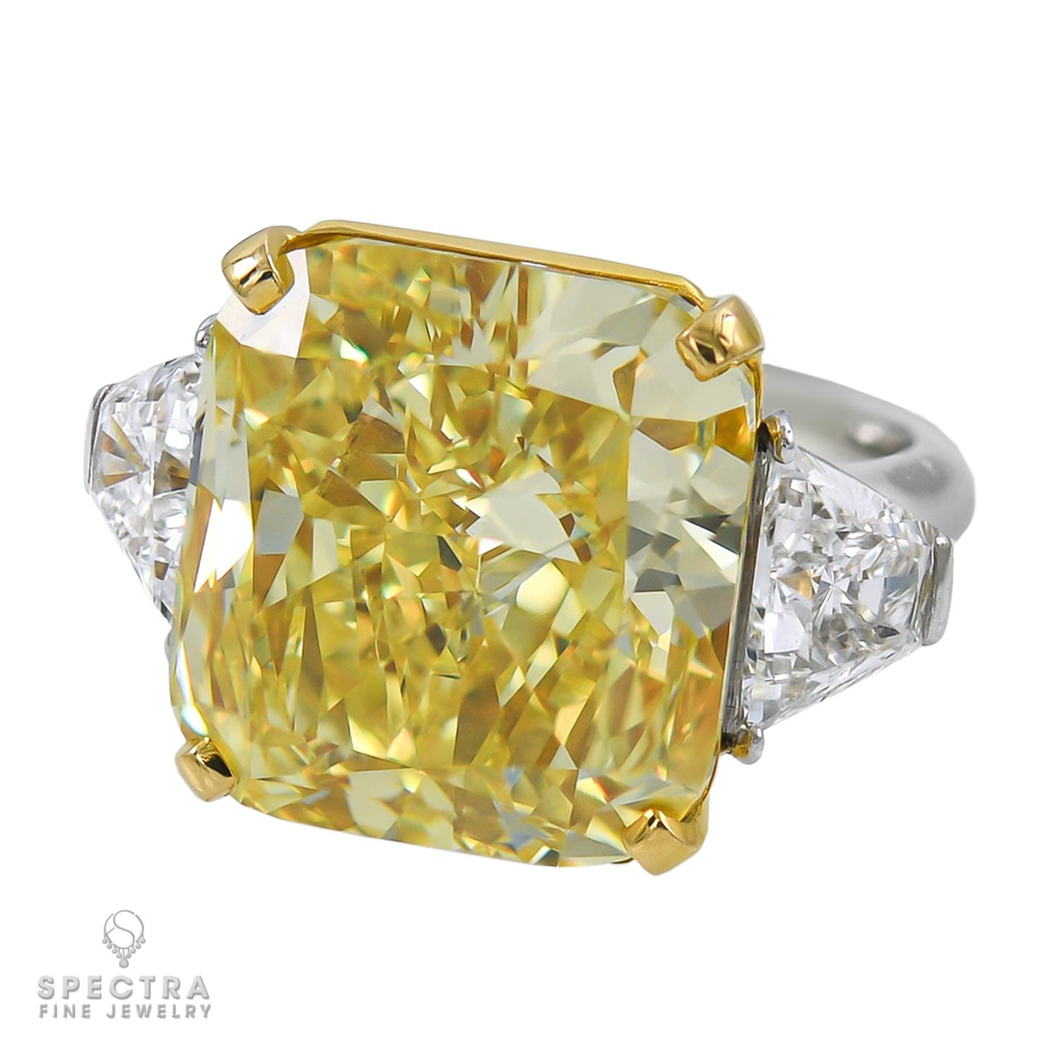 An important ring comprising of a radiant diamond weighing 22.86 carats. 
The diamond is certified by GIA stating that it's of fancy vivid yellow color, VVS2 clarity.
A copy of the GIA certificate will be provided upon request.
It's accented by two