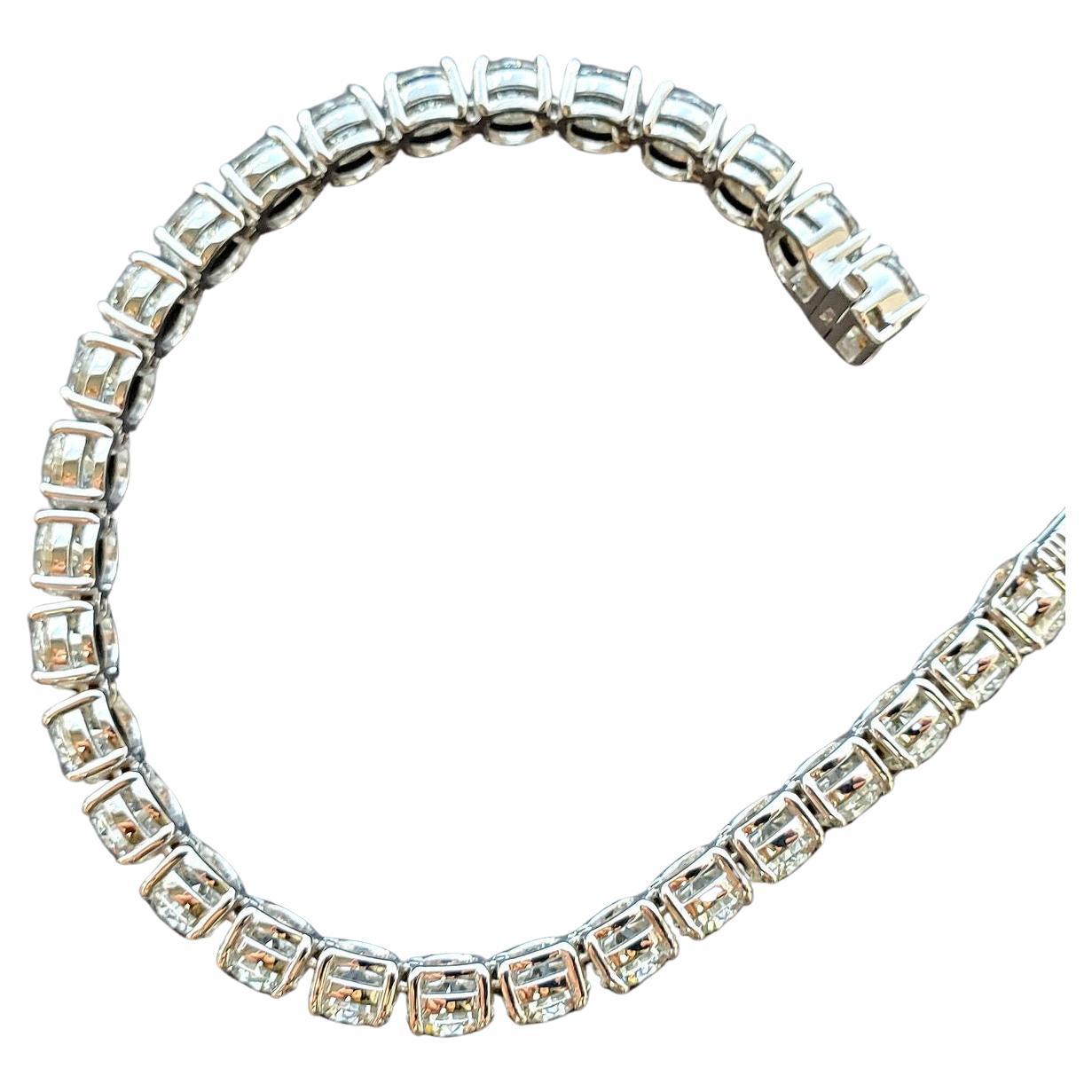 Introducing a breathtaking 23 Carat Diamond Riviere Bracelet, a masterpiece of elegance and sophistication. This exquisite bracelet is crafted in luxurious platinum, designed to wrap gracefully around the wrist, offering timeless beauty and