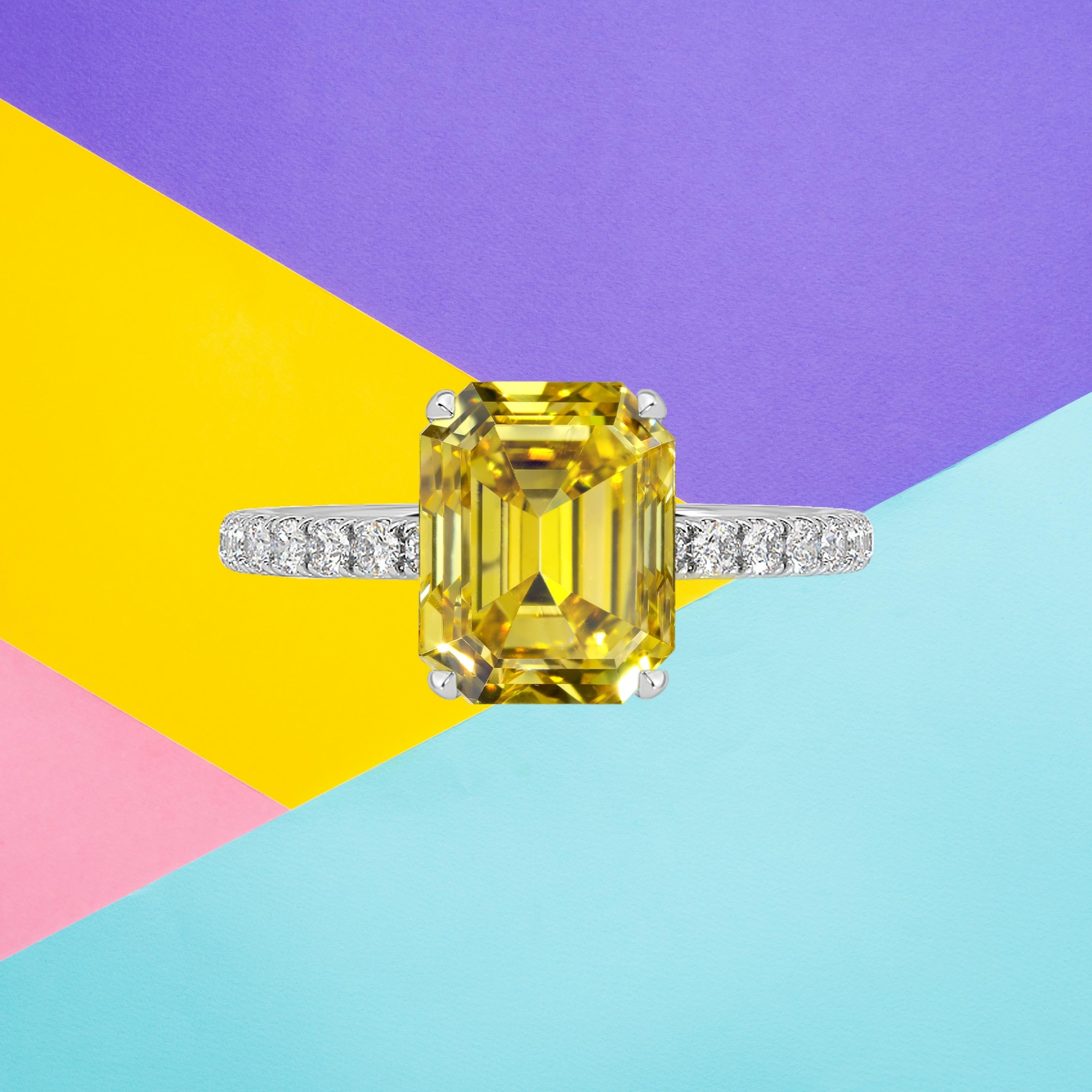 This emerald cut diamond weighs 2.30 carat and is certified 'Fancy Vivid Yellow' color by the Gemological Institute of America. The GIA has also assigned a VS2 clarity grade to the stone. The diamond has been inscribed with the certificate number to