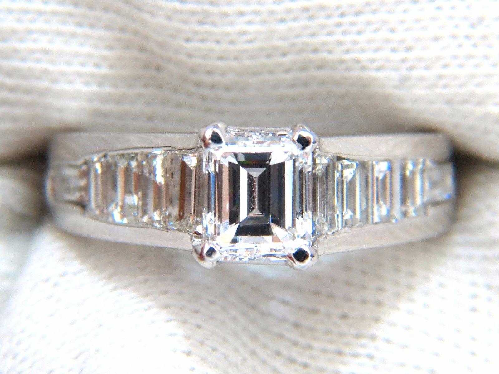 GIA 1.01ct. Emerald cut diamond Ring

D-color

Vs-2 clarity

Report: 5172274903



Side natural baguette Diamonds:  1.30ct.

Full Brilliant cuts

G Color Vs2 clarity.

14kt. white gold

5.9 Grams.

Ring Depth: 7.1mm

Current size: 6

Resizing is