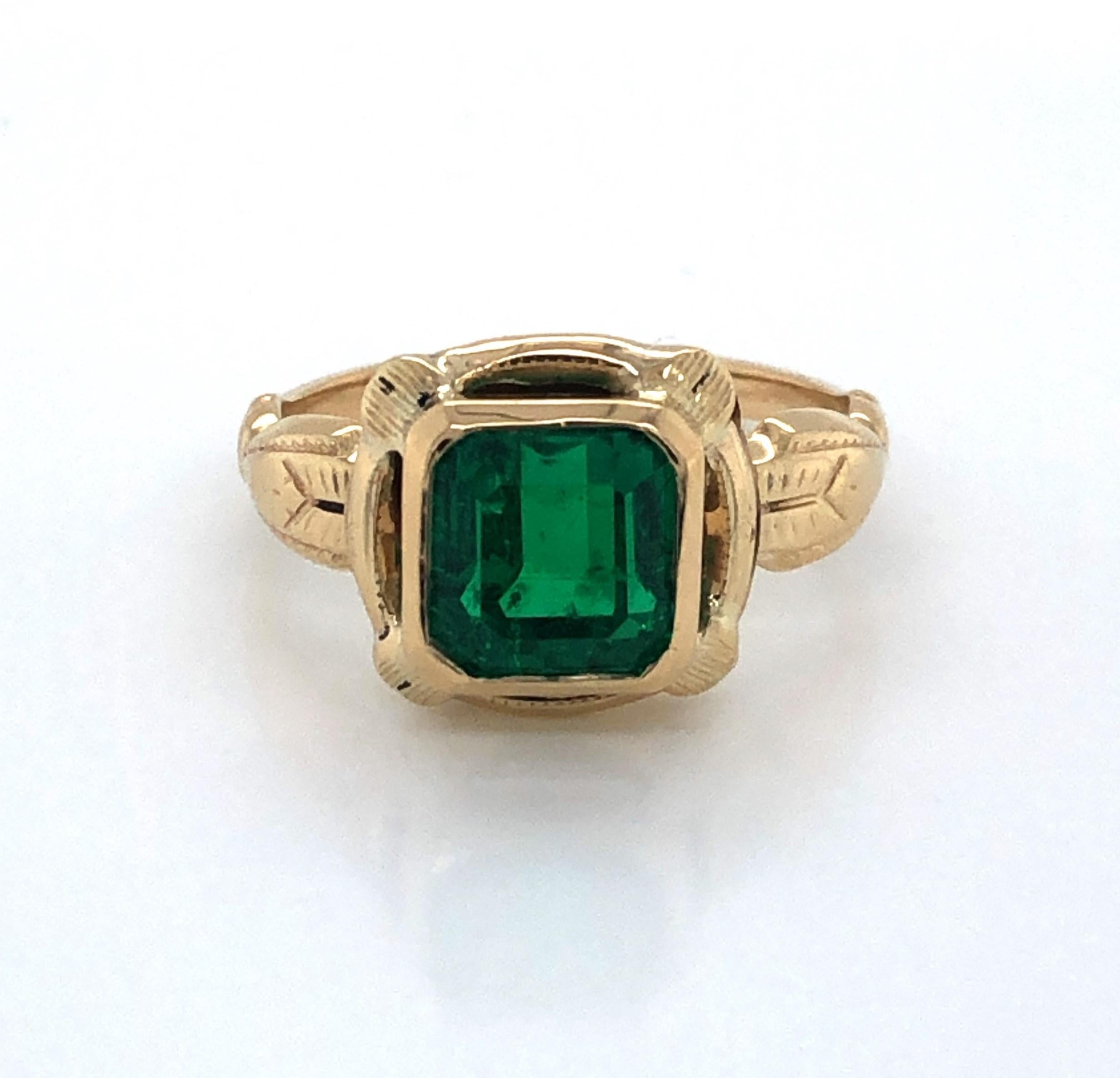 Regally displayed in it's beautiful fancy antique ten karat 10K yellow gold setting, this vibrant green step cut 2.33 carat emerald gemstone emotes the spiritual meaning of love and hope. 
GIA certified as an octagon step cut green natural beryl