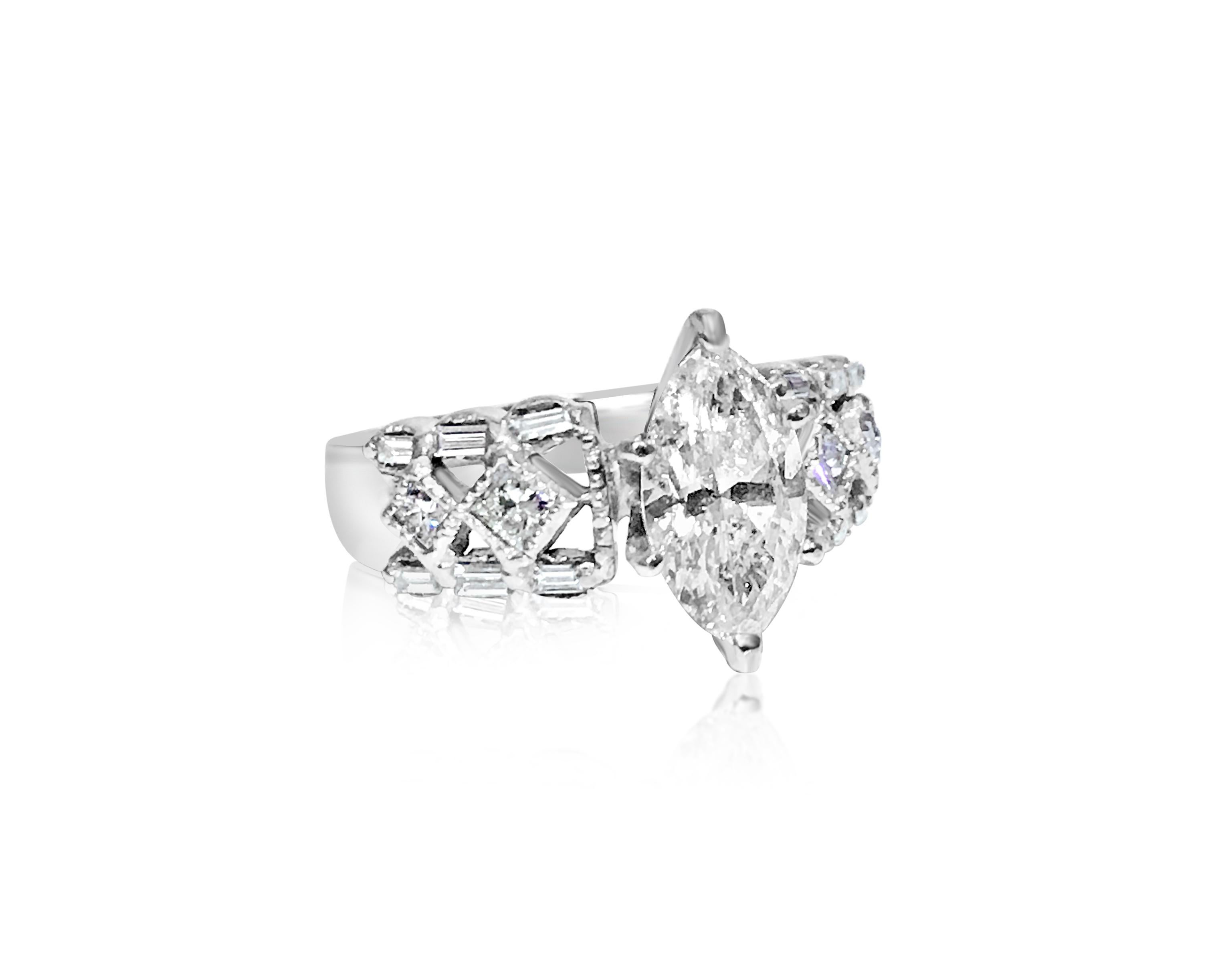 Metal: 14K white gold. 

Center diamond: 1.65 carat marquise cut diamond, 100% natural earth mined.
SI2 clarity and I color. 

Side diamonds: 0.70 carats total, VS clarity and F color. Round brilliant cut diamonds. 100% natural earth mined diamonds.