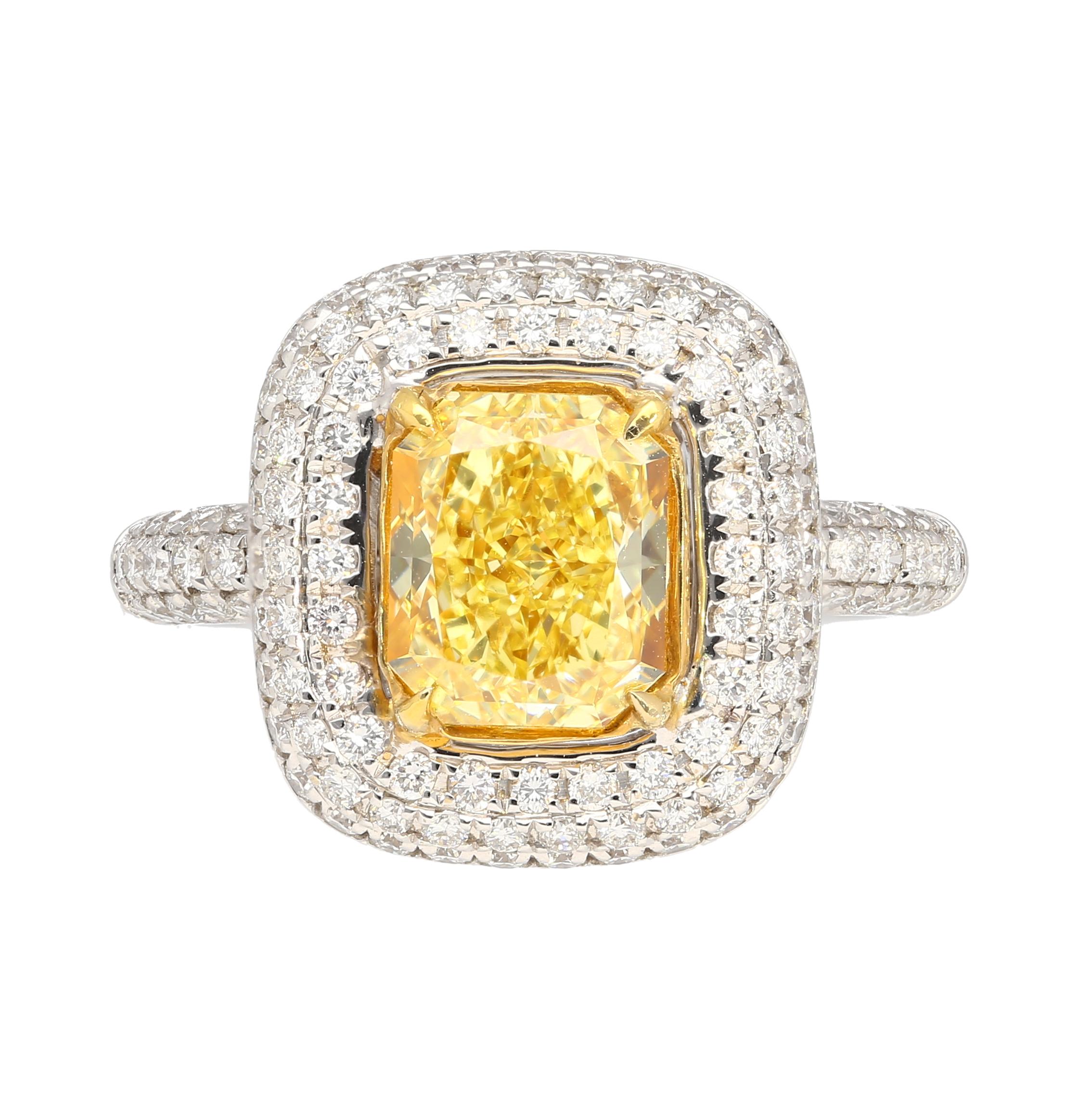 GIA certified 2.35 carat fancy yellow radiant cut diamond engagement ring. Set in 18k white and yellow gold. The ring features a dazzling round cut white diamond encrusted ring shank, yellow gold prongs, and an open back on the culet, allowing for