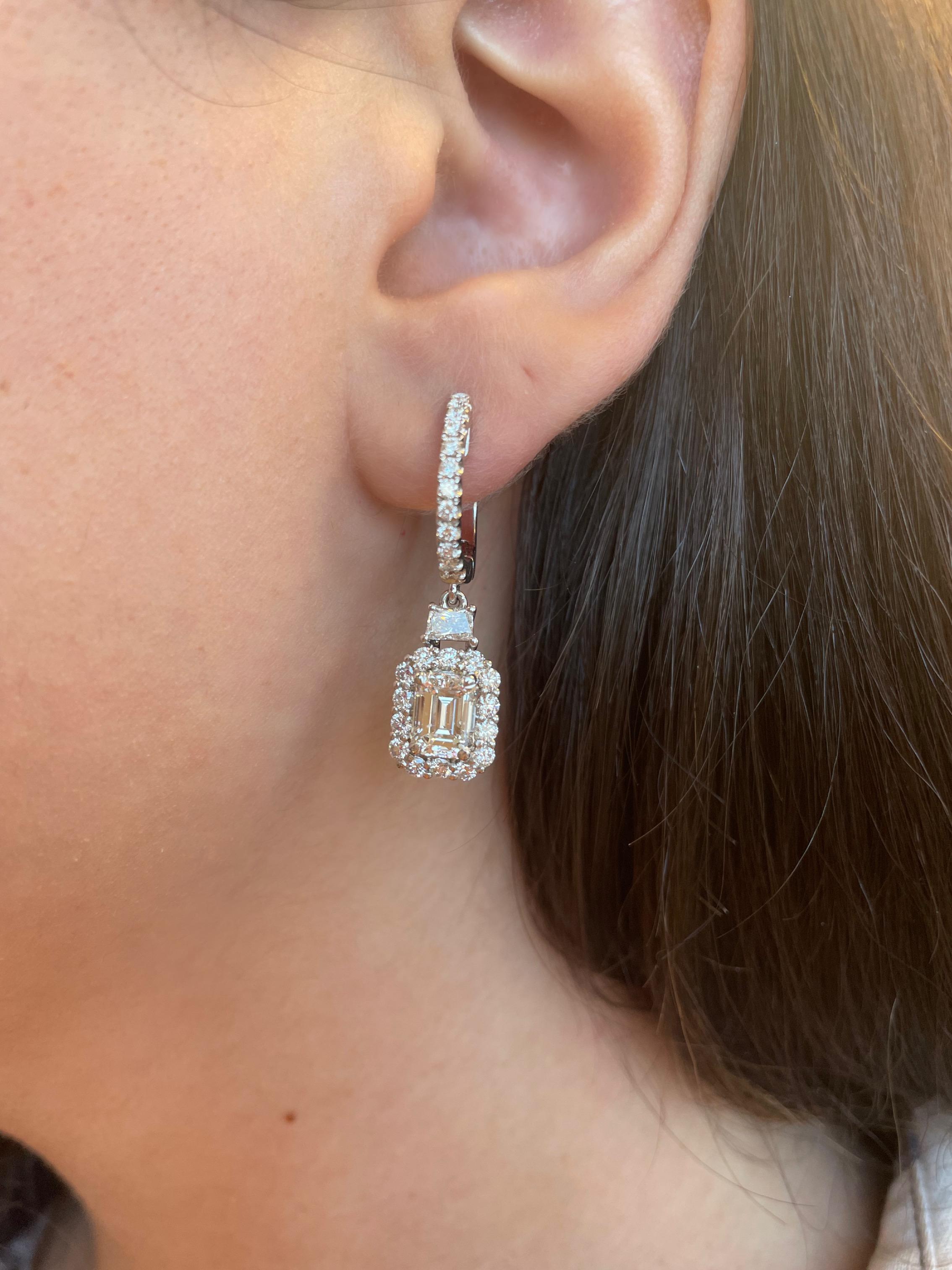 Stunning emerald cut diamond with trapezoid diamonds and halo earrings, GIA certified. High jewelry by Alexander Beverly Hills. 
4.03 carats total diamond weight. 
2 emerald cut diamonds, 2.37 carats. Both G color and VS1 clarity GIA certified.