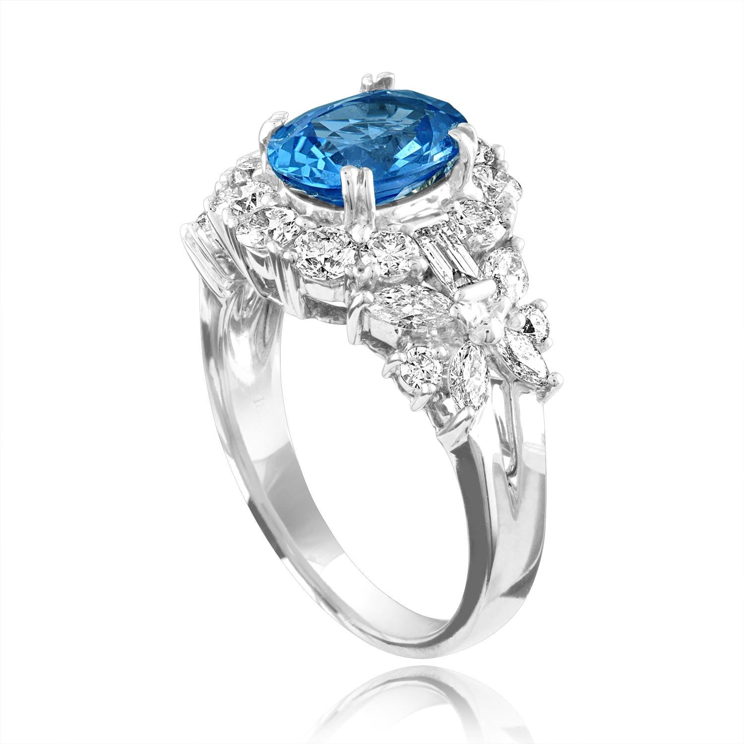 Beautifully Diamond Encrusted Oval Blue Sapphire Ring
The ring is 18K White Gold
The center stone is an oval 2.38 Carat Blue Sapphire
The Sapphire is GIA certified HEATED
There are 1.44 Carats in Diamonds F/G VS/SI
The ring is a size 6.5