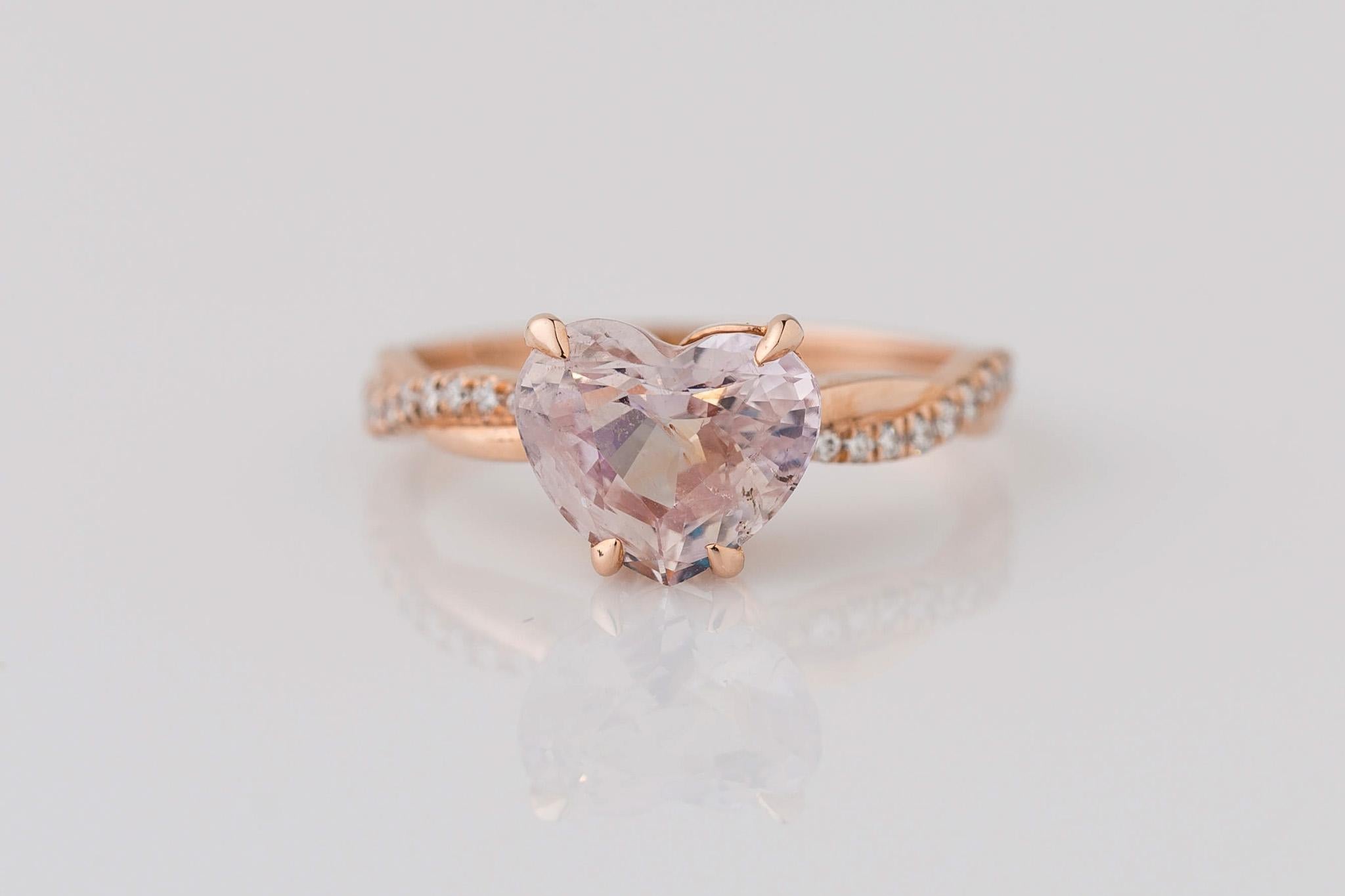 Enchant hearts with our whimsically elegant GIA certified heart shaped pink sapphire diamond twist ring. The star of the show is a dazzling 2.39Ct heart-shaped pink natural sapphire, GIA certified and unheated, measuring 7.28x8.62mm. Sparkling