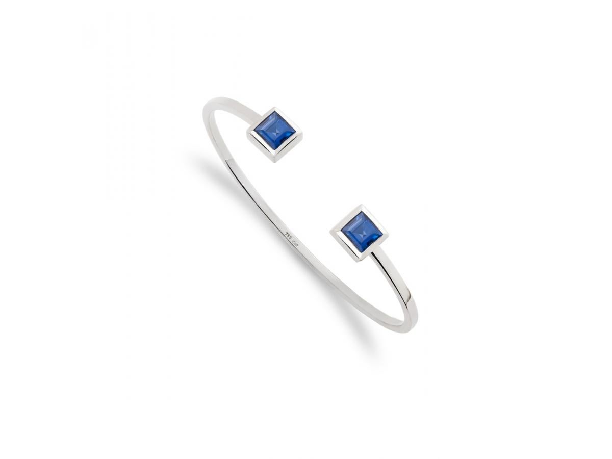 This is a classic modern le carré bangle in 18 carat white gold with two beautiful sapphires 2.4 ct designed by Colleen B. Rosenblat.