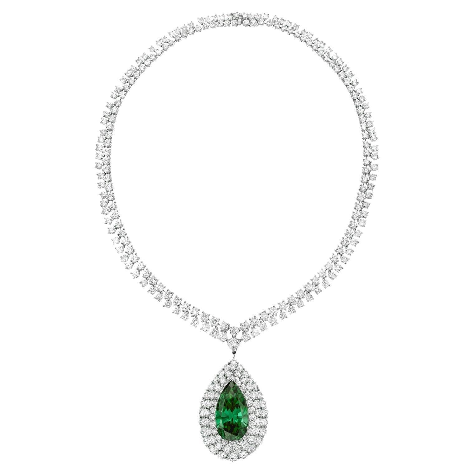 The detachable pendant centering on a 24 carat pear shaped green emerald diamond framed by round diamonds and suspened from a graduated diamond neckalce.

METAL: platinum
