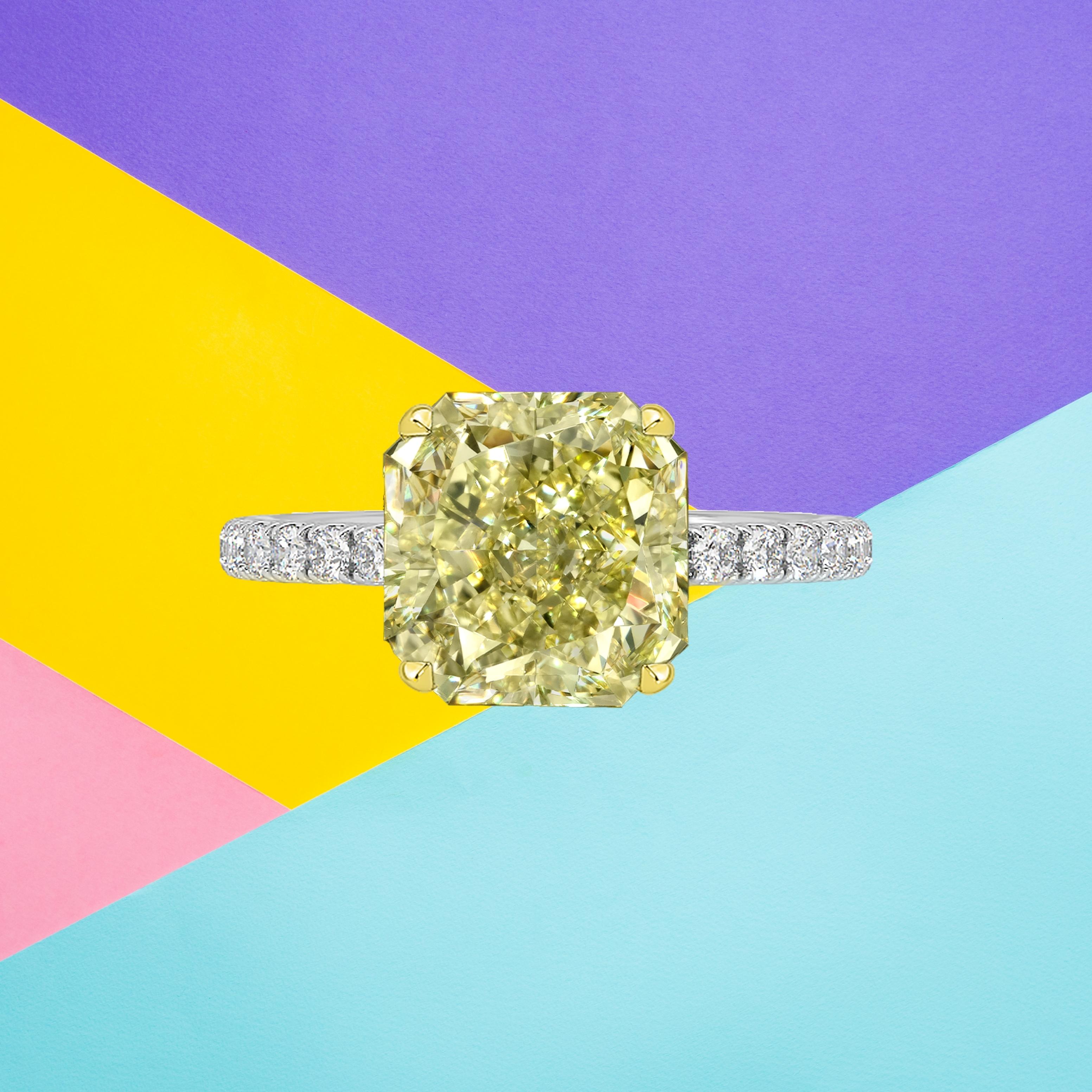 This radiant cut diamond weighs 2.40 carat and is certified 'Fancy Yellow' color by the Gemological Institute of America. The GIA has also assigned a VVS1 clarity grading to the stone. The diamond has been inscribed with the certificate number to