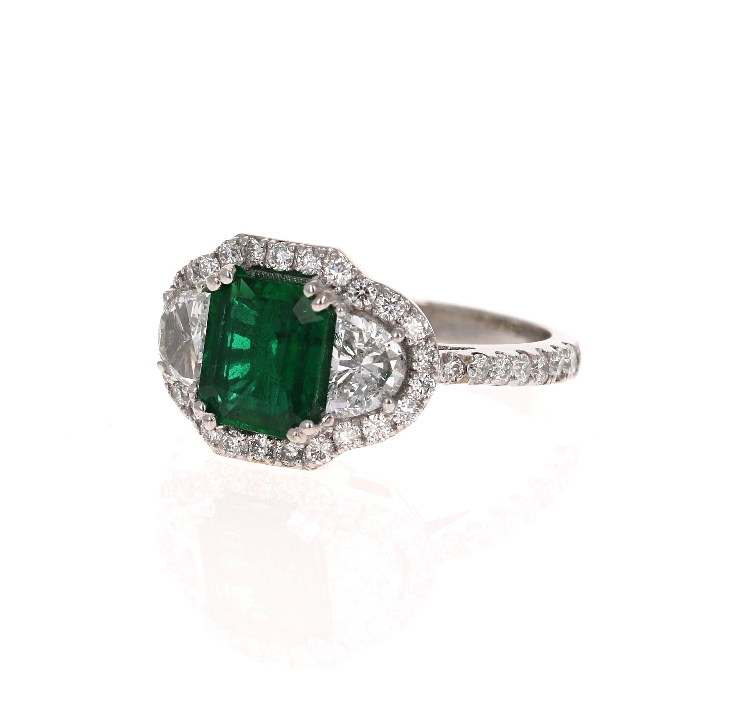 A beauty that is sure to be nothing less than a statement! 

This ring has a exquisite Emerald-Step Cut Green Emerald that weighs 1.25 Carats and has 2 Half Moon Cut Diamonds weighing 0.63 Carats. It is further embellished with 40 Round Cut Diamonds