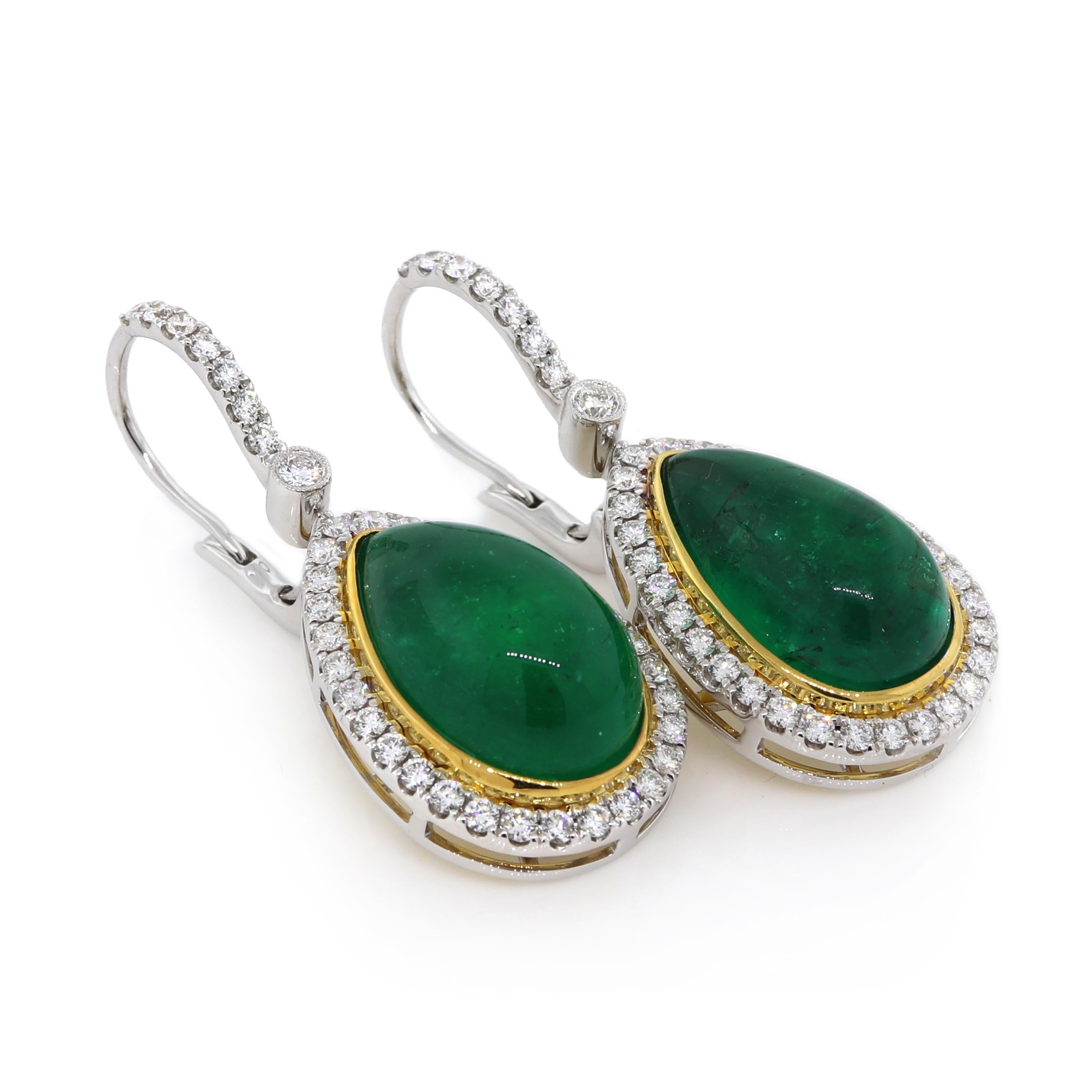 2 GIA certified cabochon pear shape emeralds of about 24.35 carats surrounded by 76 round brilliant cut diamonds of about 1.44 carats with a clarity of SI and color G. All stones are set in an 18k two tone earrings. The total weight of the earrings