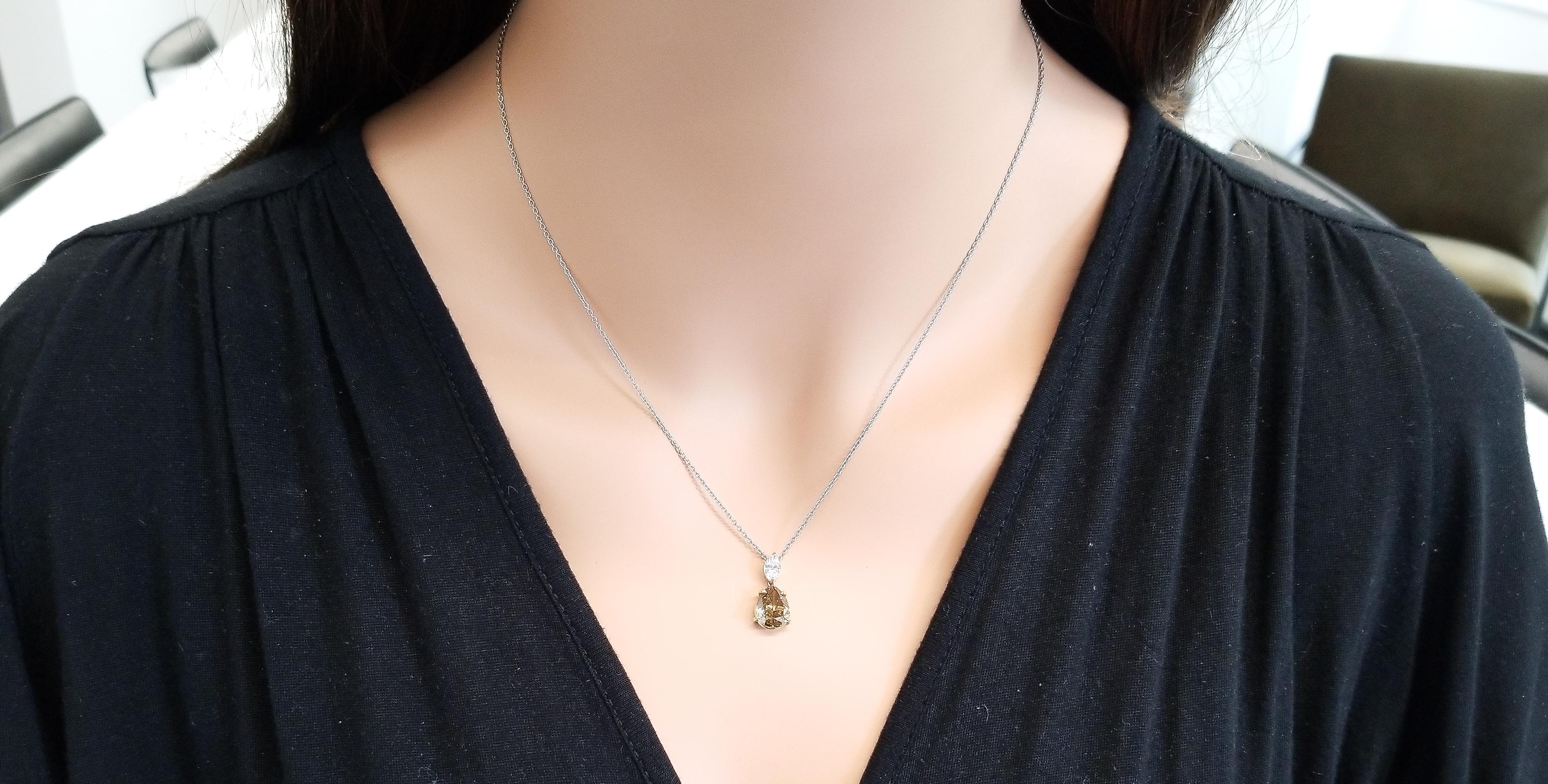 This necklace features one GIA certified pear shaped natural fancy dark brown-greenish-yellow diamond with a weight of 2.44 carats and SI2 clarity. The intense color of this diamond is complemented by a GIA certified marquise shaped natural light