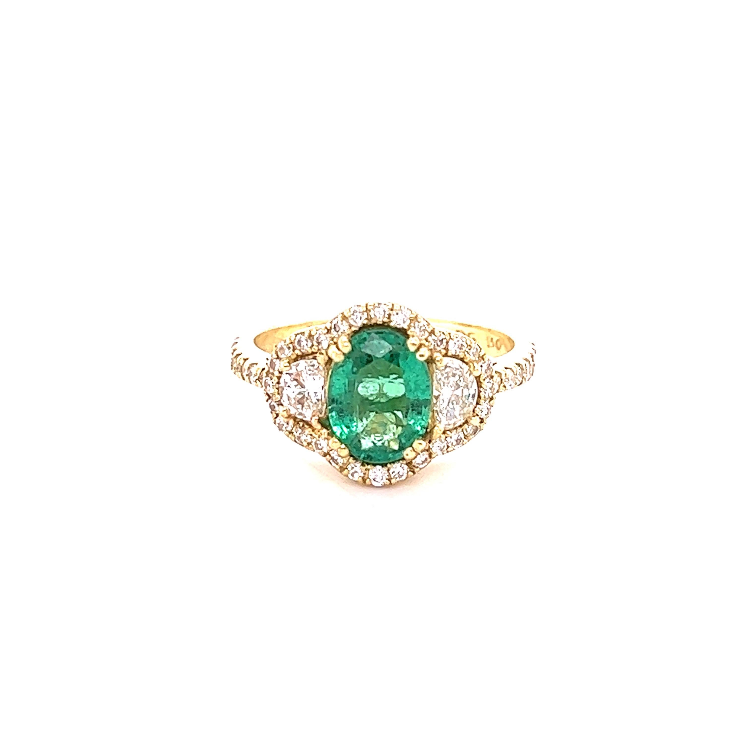 This gorgeous ring has a 1.58 carat Oval Cut Emerald that is set in the center of the ring. The Emerald measures at 9 mm x 7 mm and is surrounded by 2 Half Moon Cut Diamonds that weigh 0.47 carats with a clarity and color of VS-H and further