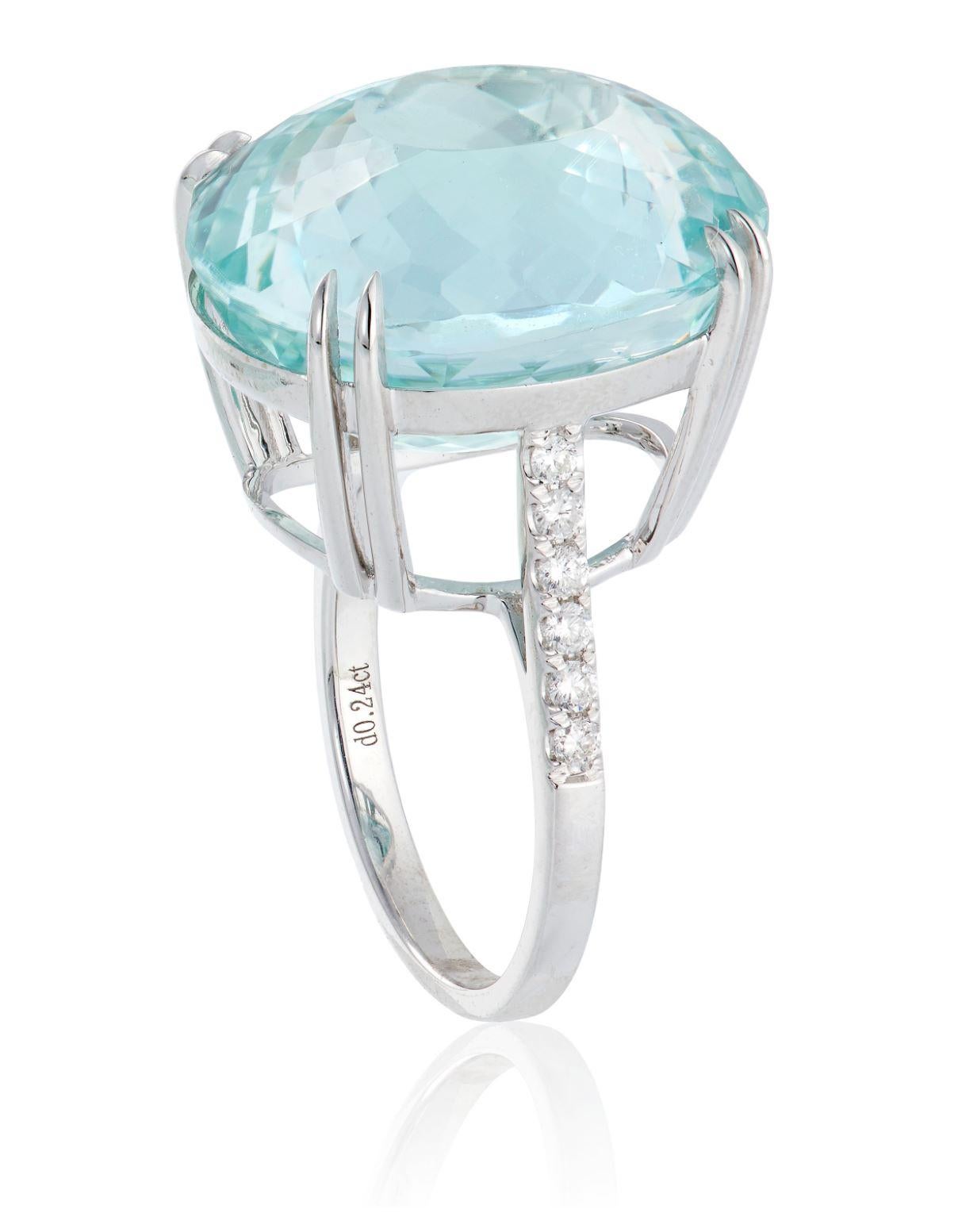 This ring features a large Paraiba tourmaline, with a transparent, greenish blue color, weighing approximately 24.77 carats, surrounded by 12 round diamonds, weighing approximately 0.24 carats, set in 18K white gold. 