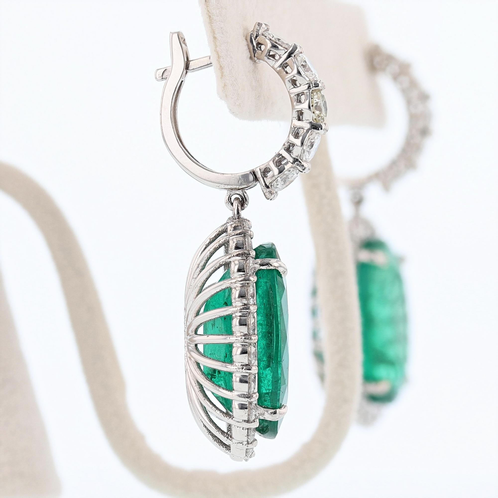 These earrings are made of 14k white gold and features 2 Oval Shape Green Emeralds weighing a combined total weight of 24.88ct, prong set. The Emeralds are GIA Certified. The first Emerald is an oval shape and weighs 12.26ct. The GIA Certification