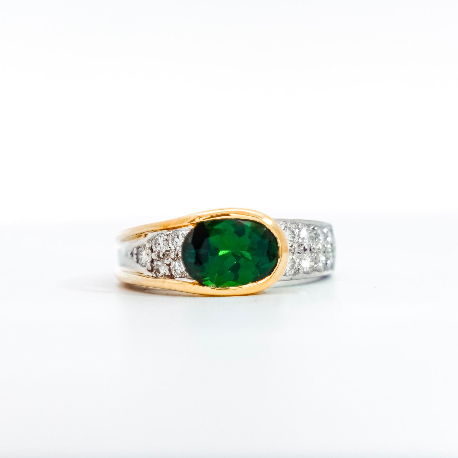 GIA Certified Green 2.50 Carat Tzavorite and Diamond Overpass 18K Gold and Platinum Ring. Signed by Richard Krementz. The center stone, Tzavorite, belongs to the Grossular Garney semi-precious species. This ring features a gorgeous overpass design