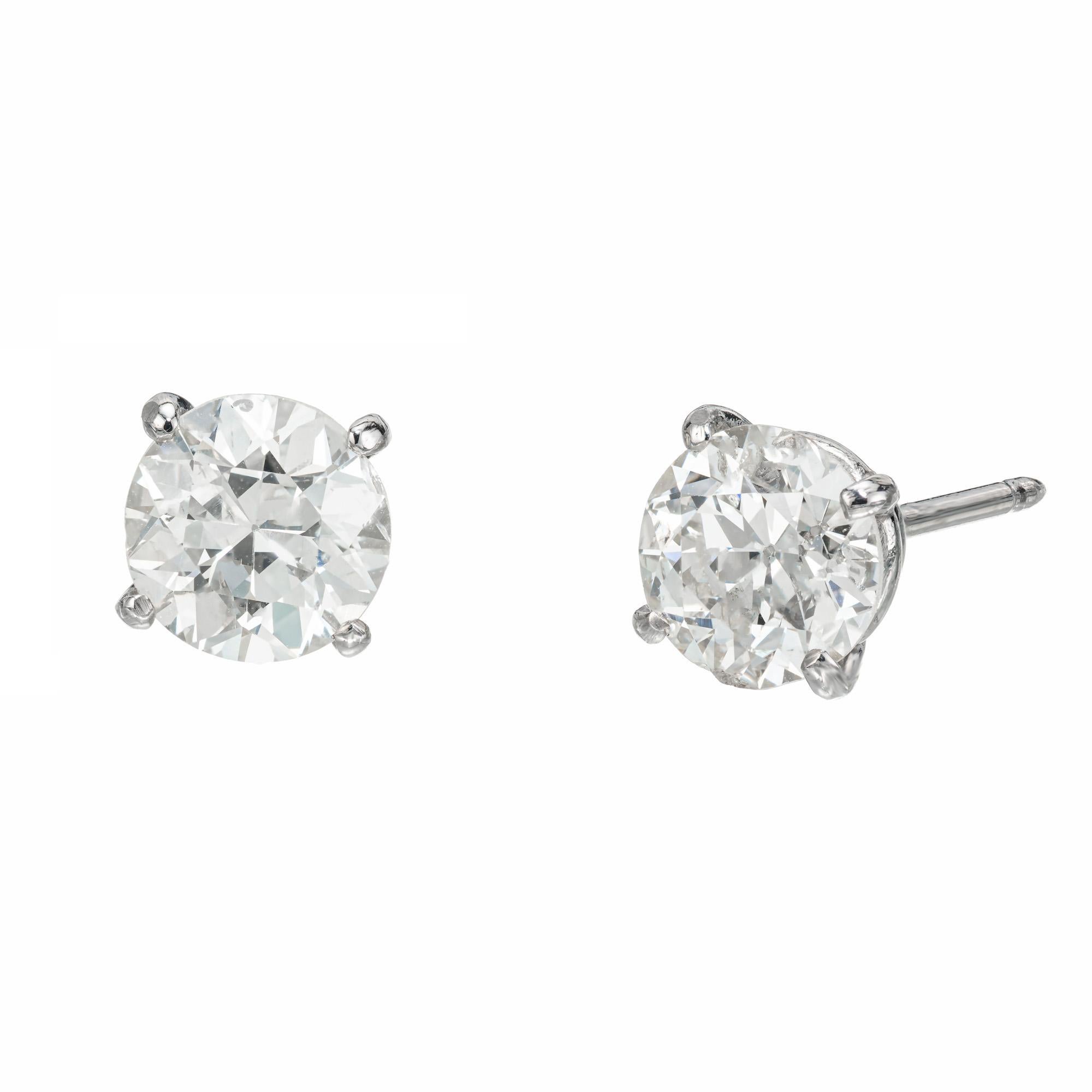 2 round GIA certified diamonds set in platinum 4 prong basket settings.  

1 round old European cut diamond, L I2 approx. 1.23cts GIA Certificate # 2221033431
1 circular brilliant cut diamond, L I approx. 1.27cts GIA Certificate #