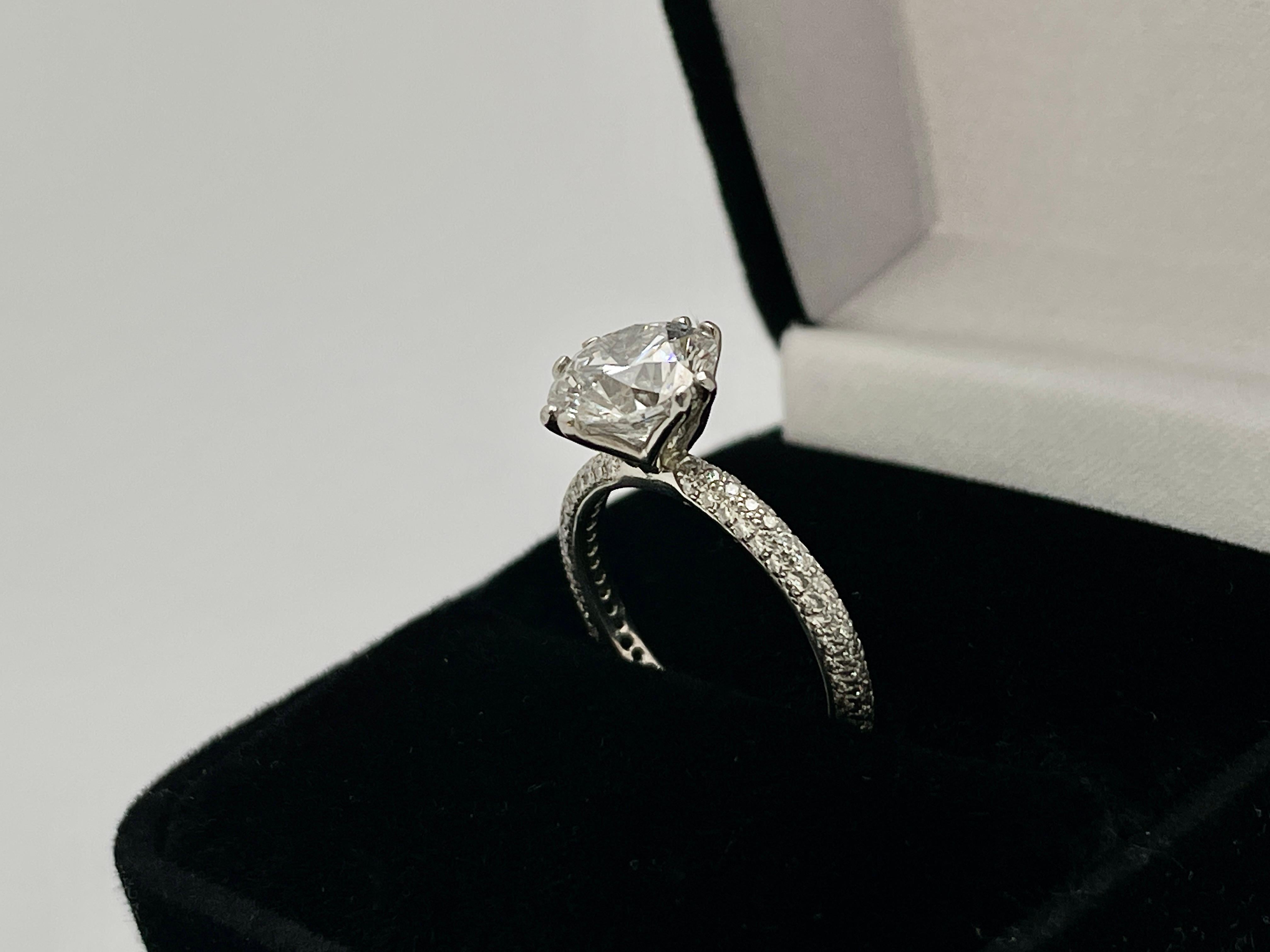 An original GIA certified diamond engagement ring, centered with one natural round brilliant cut diamond weighing 2.41 CT, measuring 8.58 - 8.66 x 5.40 mm, E color, SI2 clarity. Mounted on a hand-made platinum creative twin prong setting, with
