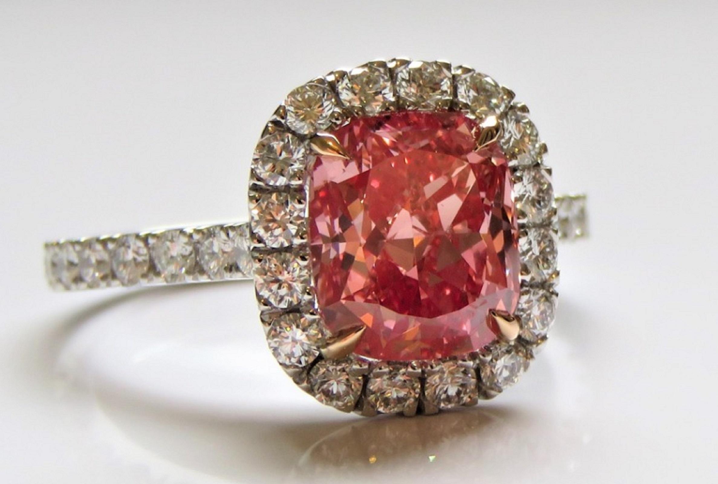 An exquisite ring composed by a stunning 2 carat fancy vivid orangy pink with an amazing saturation of color!

The ring is stunning!

The diamond is not only full of life and brilliance but is also 100% eye clean!

