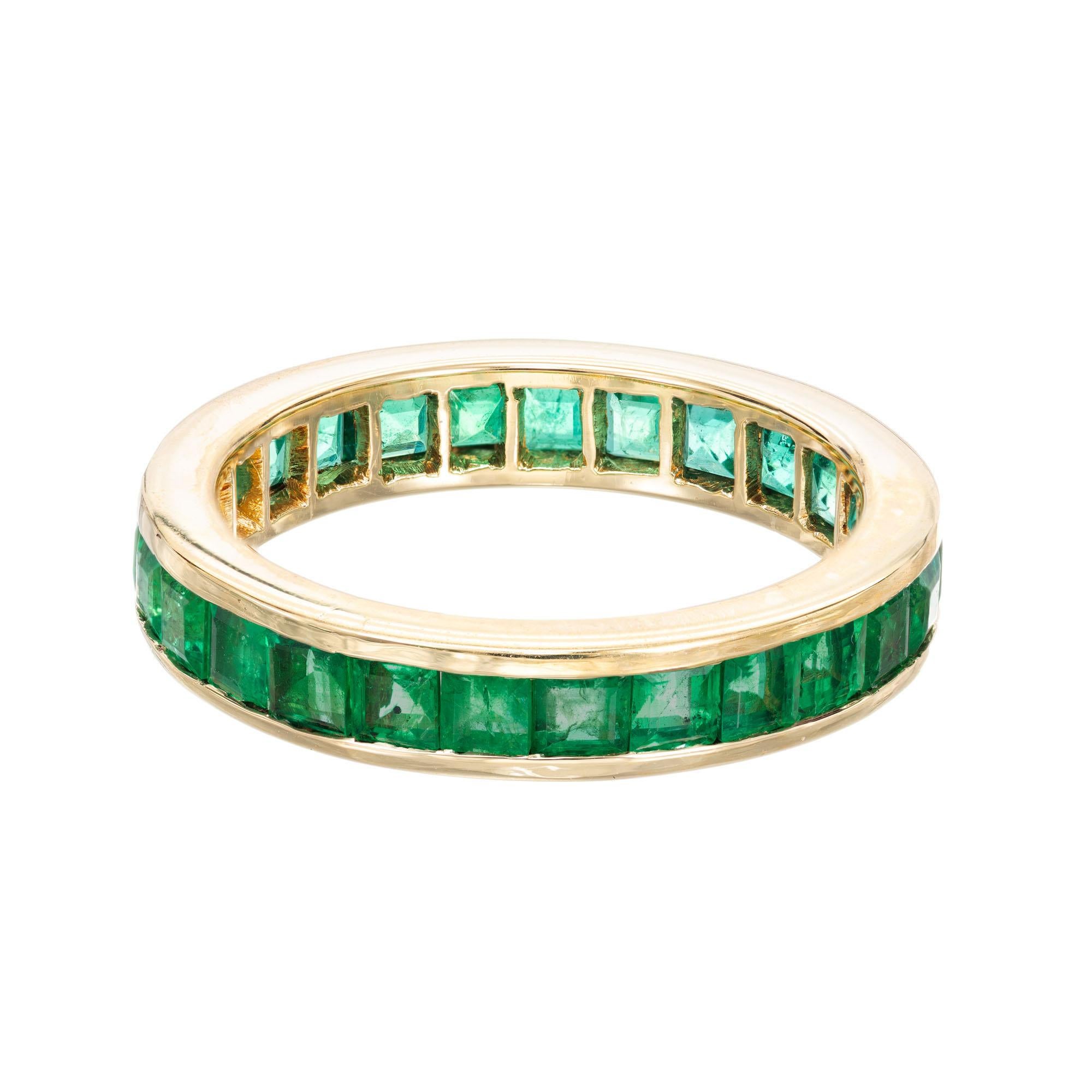 GIA certified bright green square step cut emerald eternity ring. 26 channel set square cut emeralds, in a 18k yellow gold setting. GIA certified natural emerald. CE F1

26 step square cut green emeralds, MI approx. 2.50cts Natural Emerald GIA
