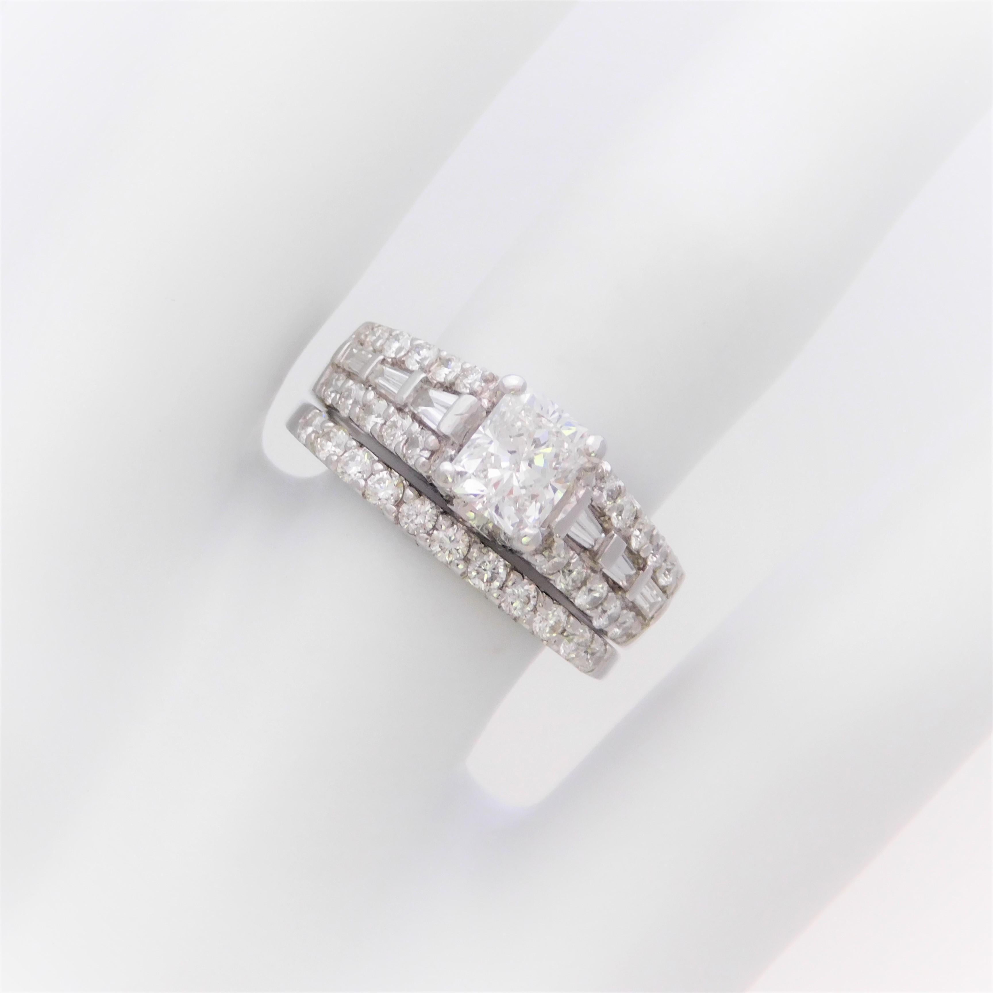 This absolutely jaw dropping bridal set has been crafted in solid 14k white gold.  The custom designed engagement ring has been masterfully jeweled, in a 4-prong setting, with an extremely high quality natural 1.01ct Radiant-cut diamond as its