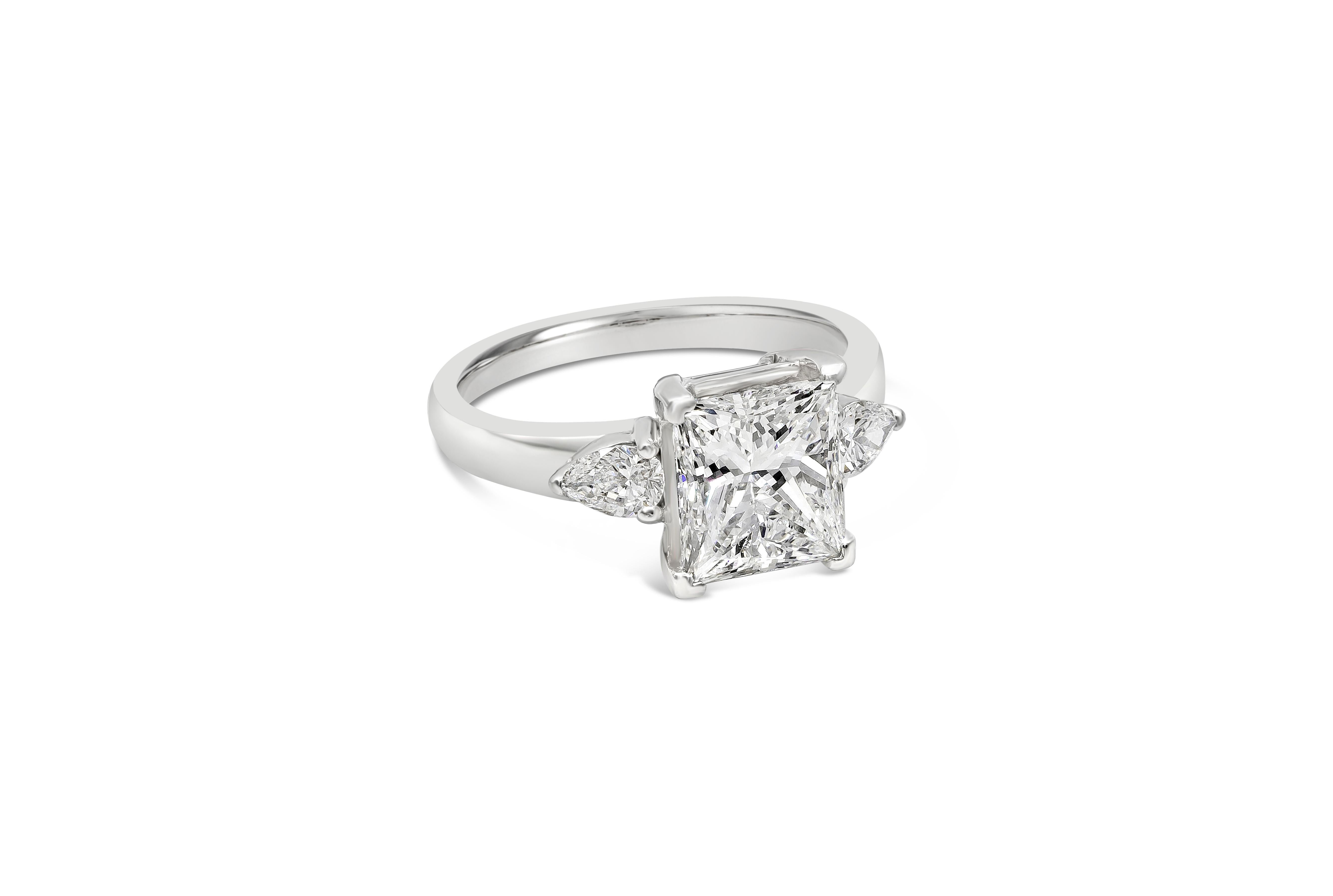 A beautiful engagement ring style showcasing a brilliant princess cut diamond certified by GIA as F color, VS2 clarity. Flanking the center diamond are brilliant pear shape diamonds weighing 0.40 carats total. Set in an everlasting platinum