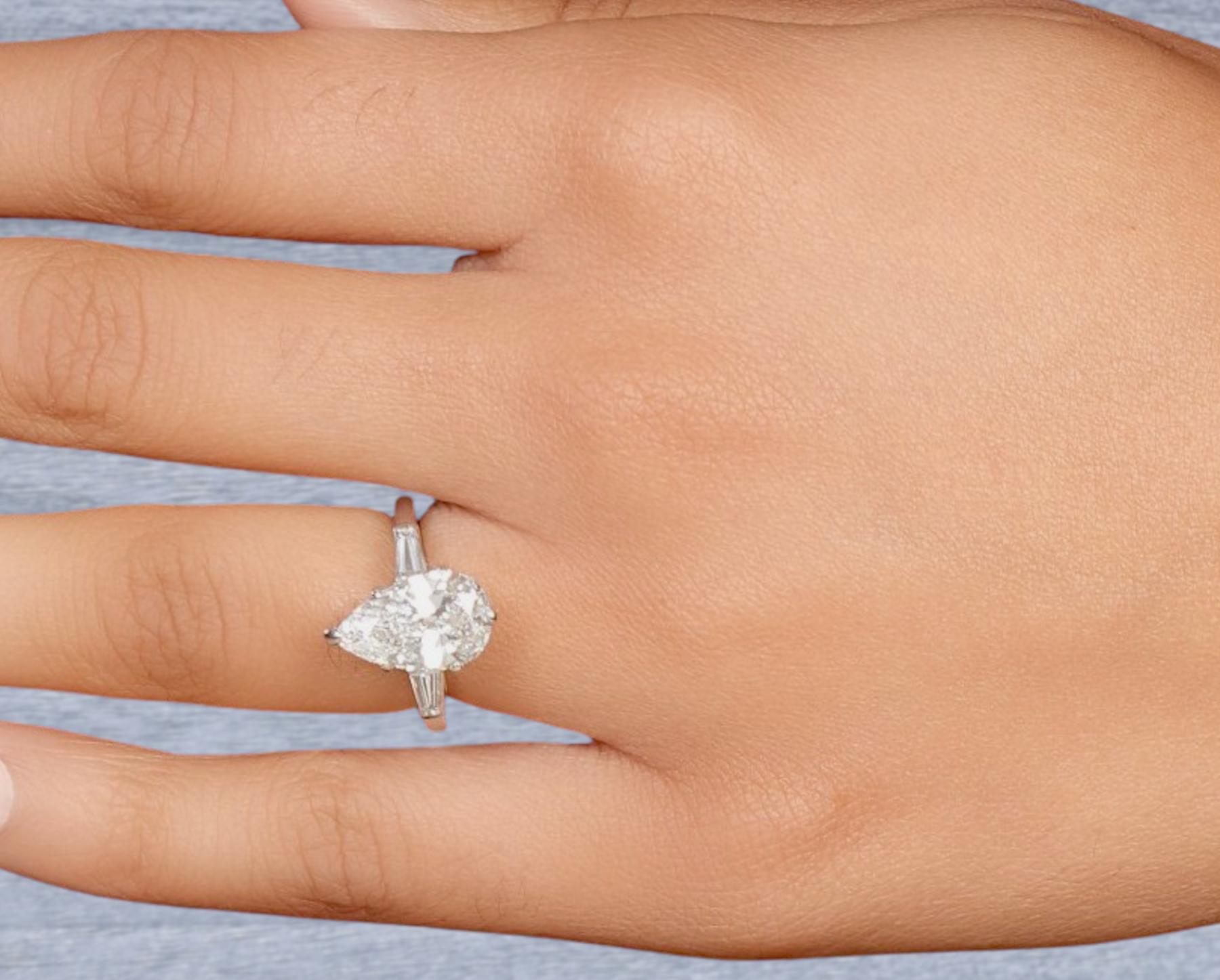 2.5 carat pear diamond ring on hand