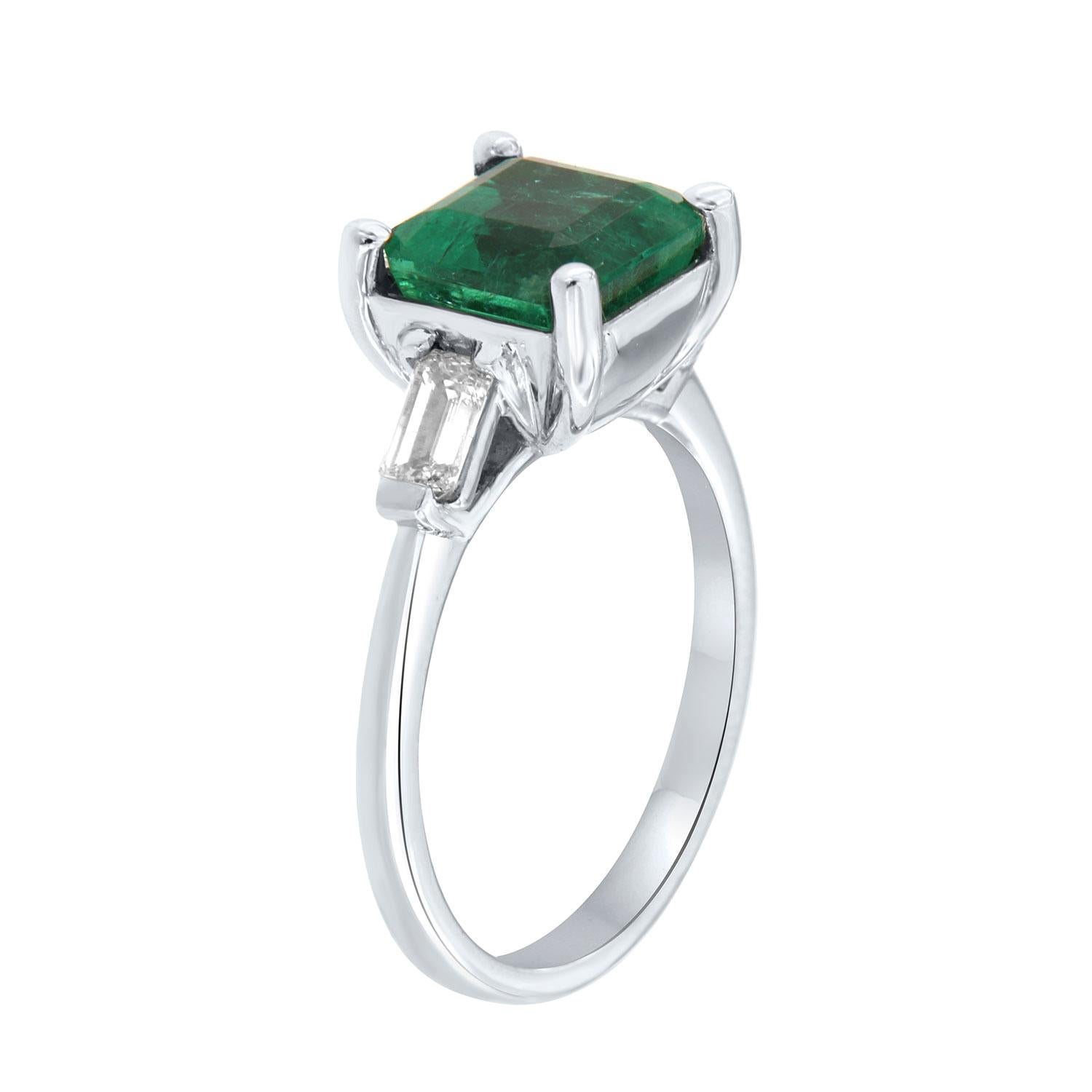 This classic Platinum ring features a 2.54 Carat Asscher cut shaped green Natural Emerald flanked by two(2) Baguette-shaped diamonds in a total weight of 0.40 Carat on a 1.7 mm wide band. 
This Ethiopian Emerald exhibits a bright green color in a