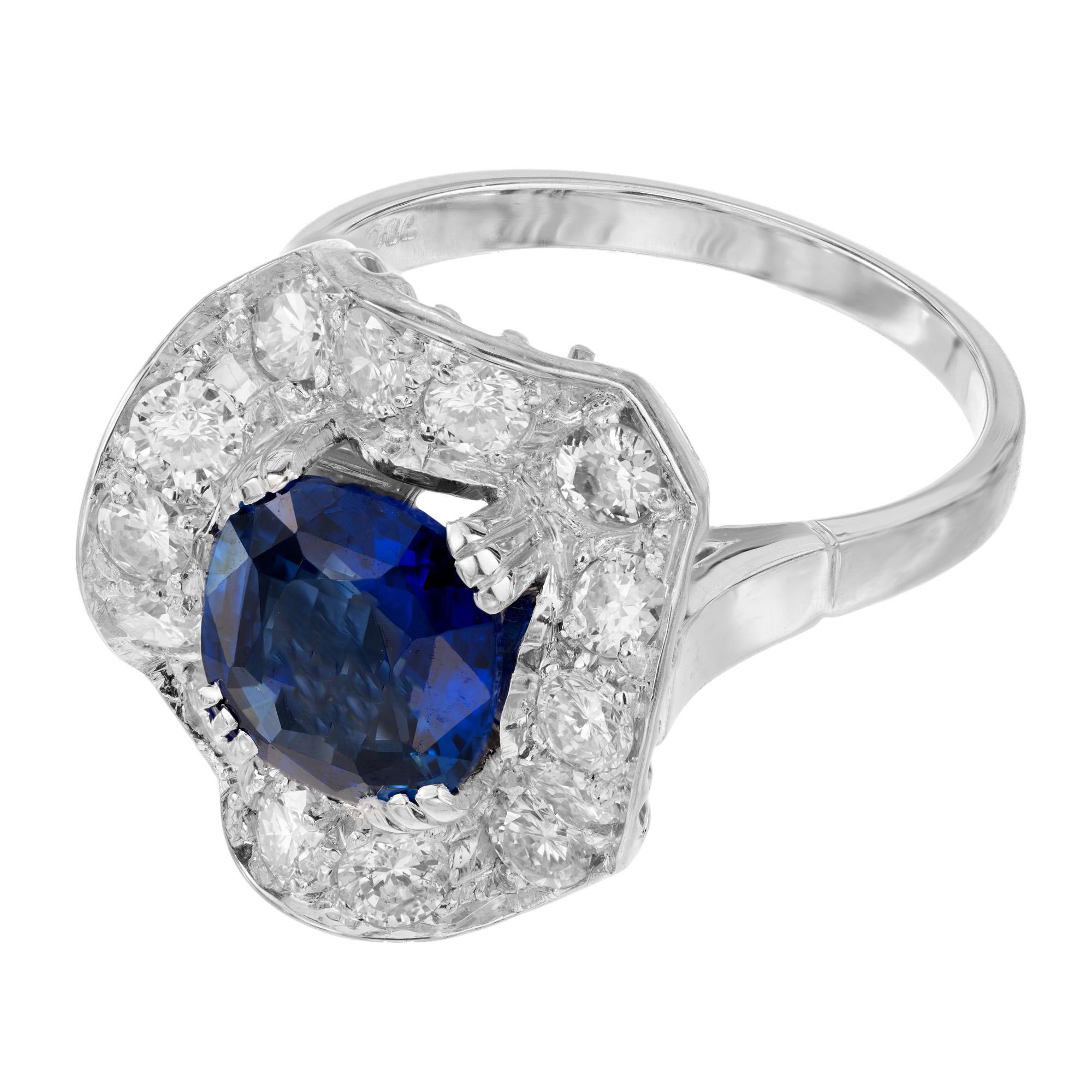 Stunning vintage 1940s sapphire and diamond halo wave design engagement ring. Mounted with a 2.54cts cushion cut sapphire, GIA certified as simple heat only. A unique wave style design surrounds the sapphire with a halo of 14 round cut diamonds in a